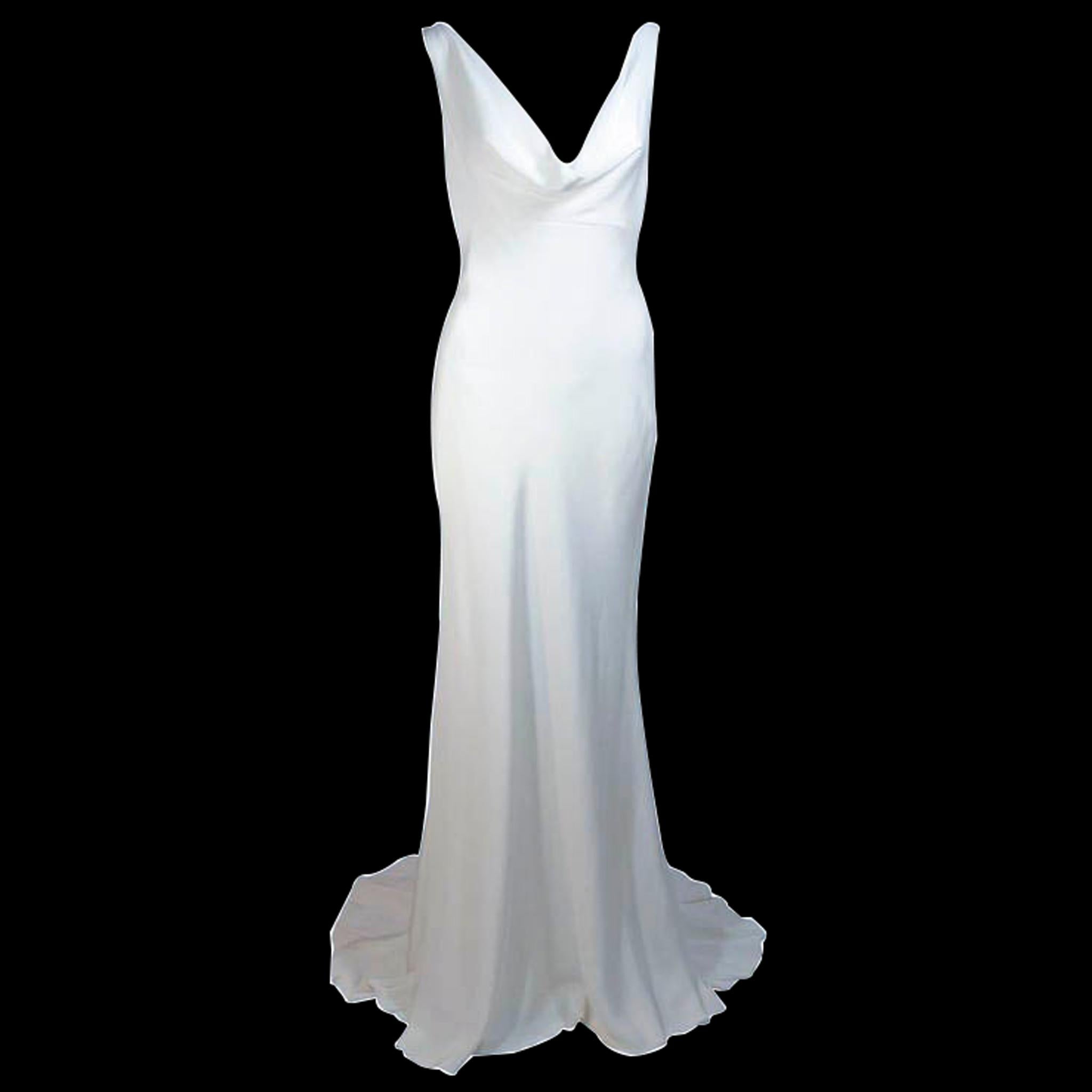 This Monique Lhuillier gown is composed of an off-white silk with a bias cut. The striking neckline is accented by a sweeping train. 
There is a zipper closure. In excellent condition, never worn. 
Made in France.

**Please cross-reference