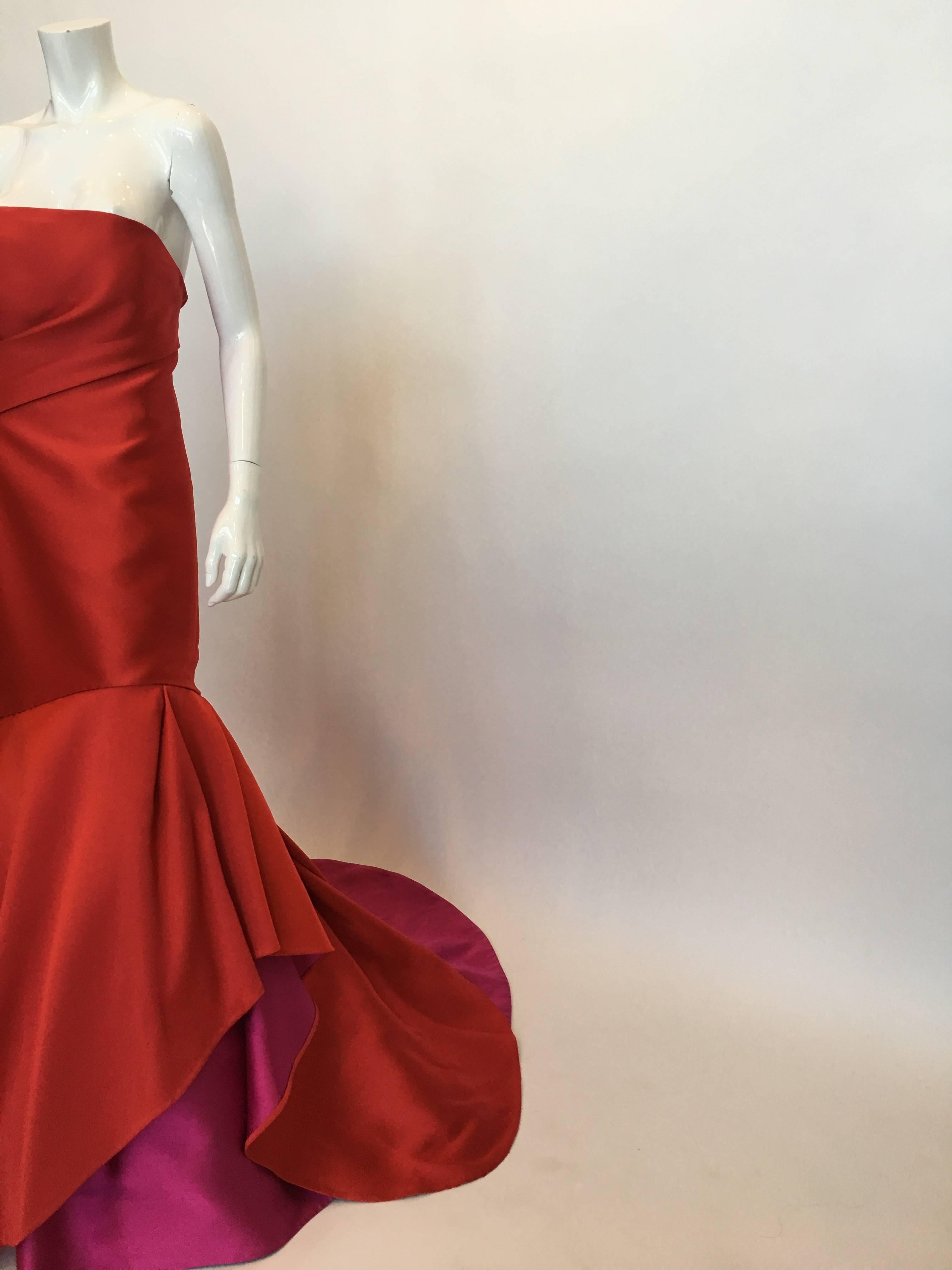 Monique Lhuillier Red Strapless Silk Gown. Back zip closure, long tail with Fuchsia underskirt and black tulle petticoat.

*ALL MEASUREMENTS TAKEN FLAT*
Size Label: 12

Bust: 34.5