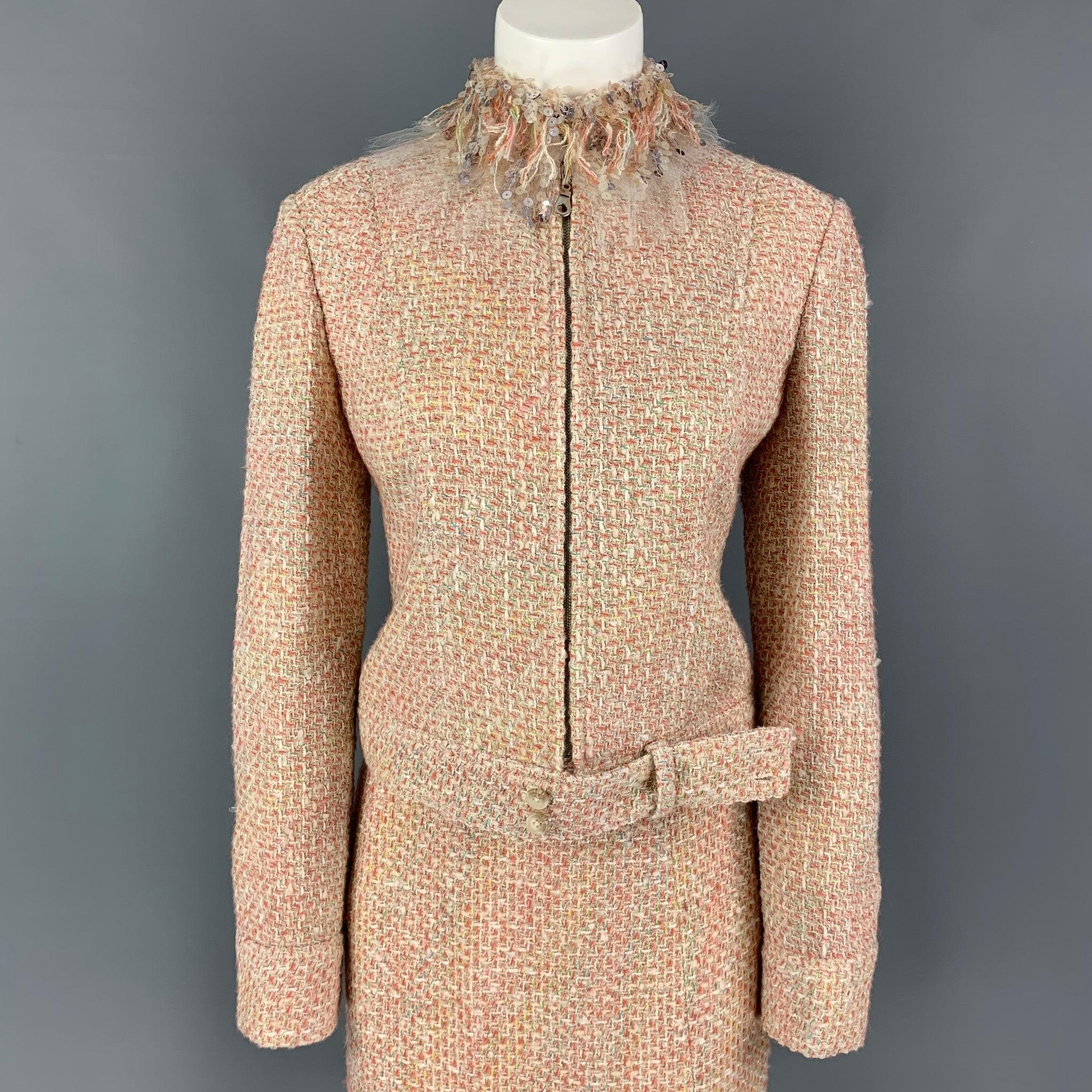 MONIQUE LHUILLIER skirt set comes in a beige & salmon boucle viscose blend jacket featuring a sequined fringe collar, strap detail, full zip up closure, and a matching pencil skirt. Made in USA.
Very Good
Pre-Owned Condition. 

Marked:   Jacket Size