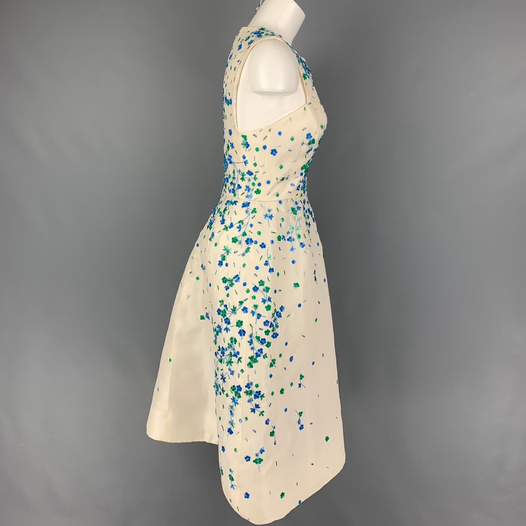 MONIQUE LHUILLIER cocktail dress comes in a cream silk with blue & green floral sequined details featuring a a-line style, sleeveless, ad a back zip up closure. Made in USA. 

Very Good Pre-Owned Condition.
Marked: 6

Measurements:

Shoulder: 12.75