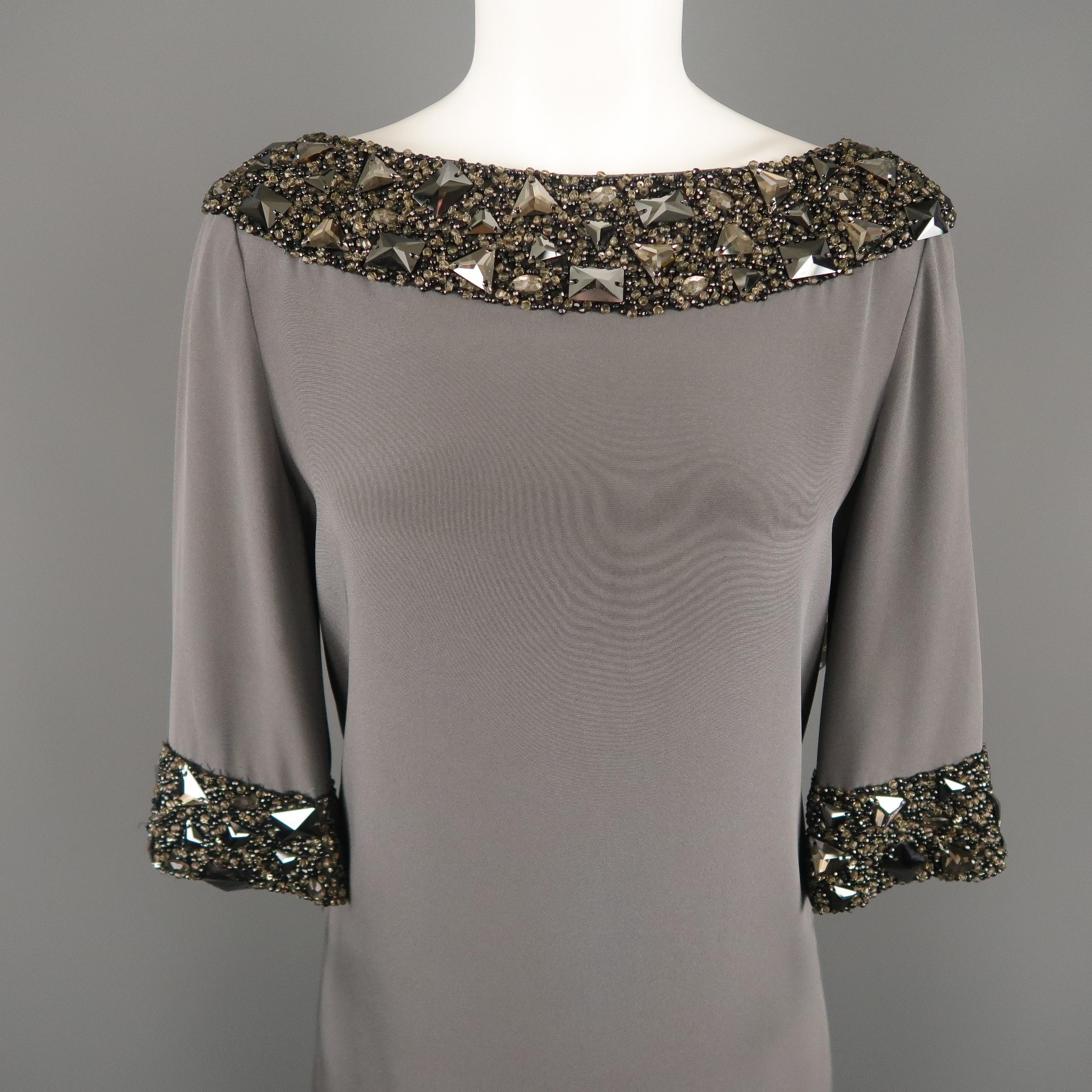 MONIQUE LHUILLIER cocktail dress comes in gray silk with a wide boat neck, A line shift silhouette, three quarter sleeves, and thick beaded trim with oversized jewel appliques. Made in USA.
 
Excellent Pre-Owned Condition.
Marked: 6
 
Measurements:
