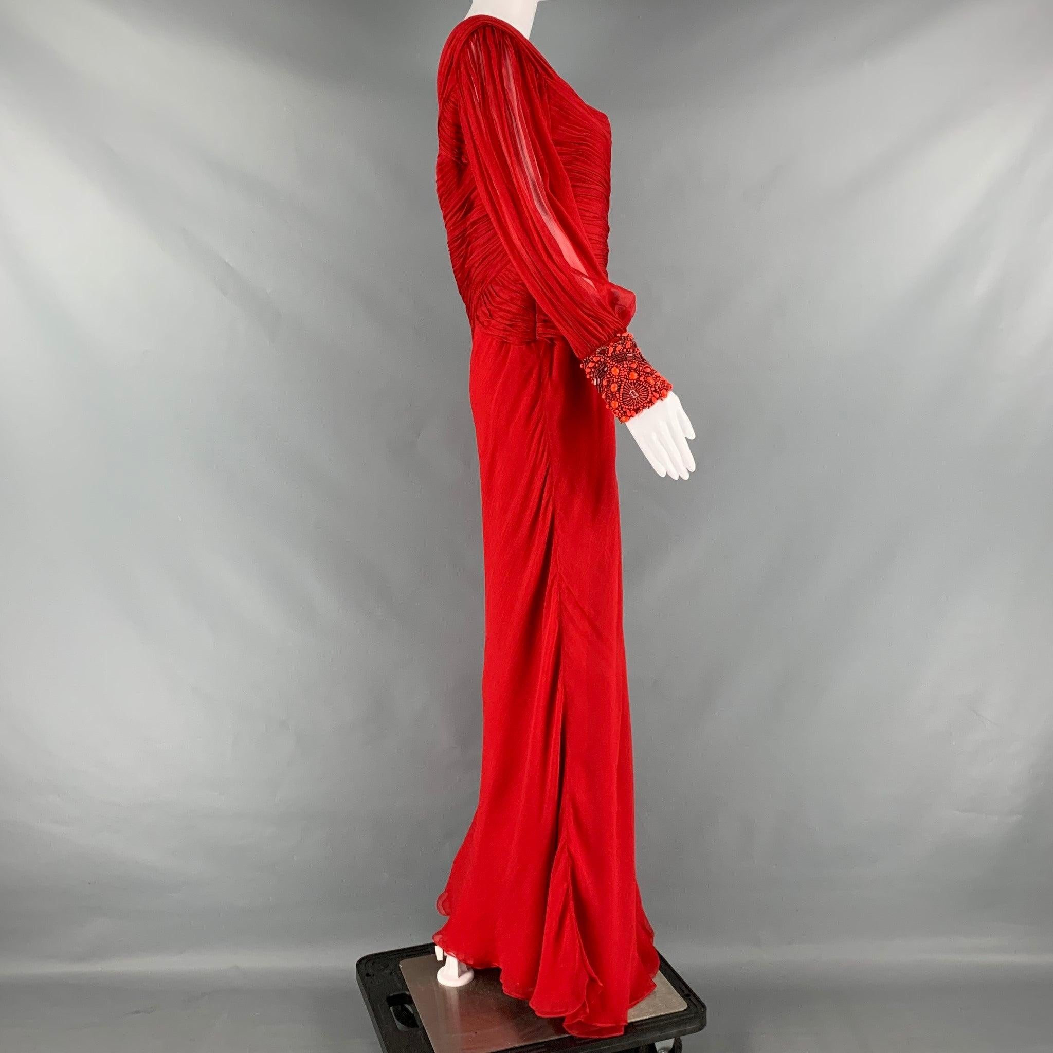 MONIQUE LHUILLIER gown comes in red woven material and features a ruched top, one shoulder design, see through sleeve, and beaded cuff.
 Very Good Pre-Owned Condition.
Tags removed. 

Marked:   M 

Measurements: 
  Bust: 36 inches Waist: 34 inches