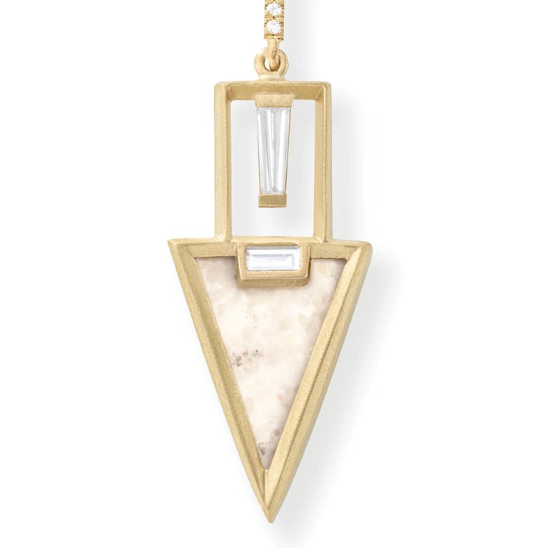 Cream fossilized dinosaur bone triangular earrings with white diamond baguettes and white diamond pavé, 18 carat recycled yellow gold, 0.61 TCW

Suspended beneath white diamond baguettes, gold and white diamond pavé, the remarkable natural