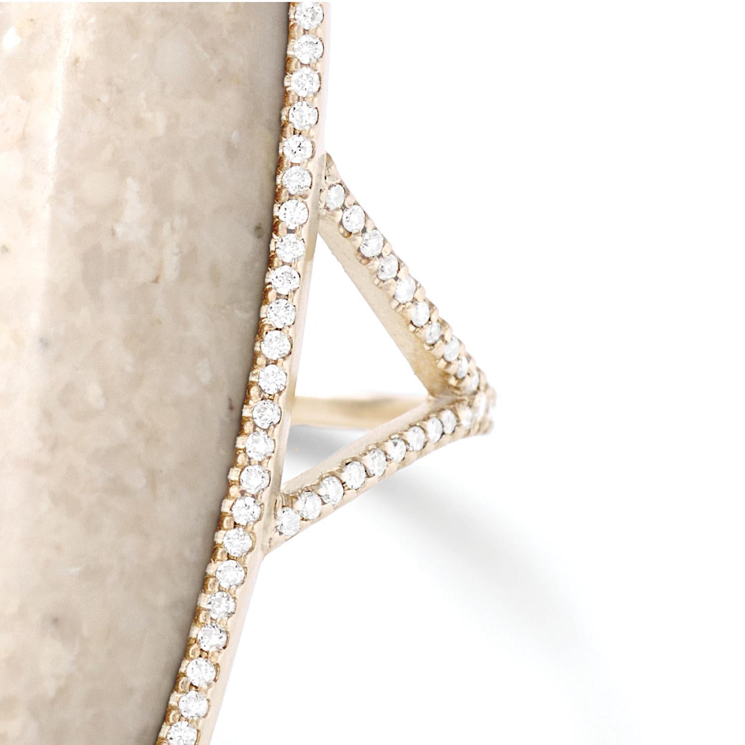 Cream fossilized dinosaur bone cabochon ring with white diamond pavé, 18 carat recycled white gold, 0.51 TCW

The cream hues of this specimen of fossilized dinosaur bone are accented by  white diamond pavé that traces the outline of this elongated