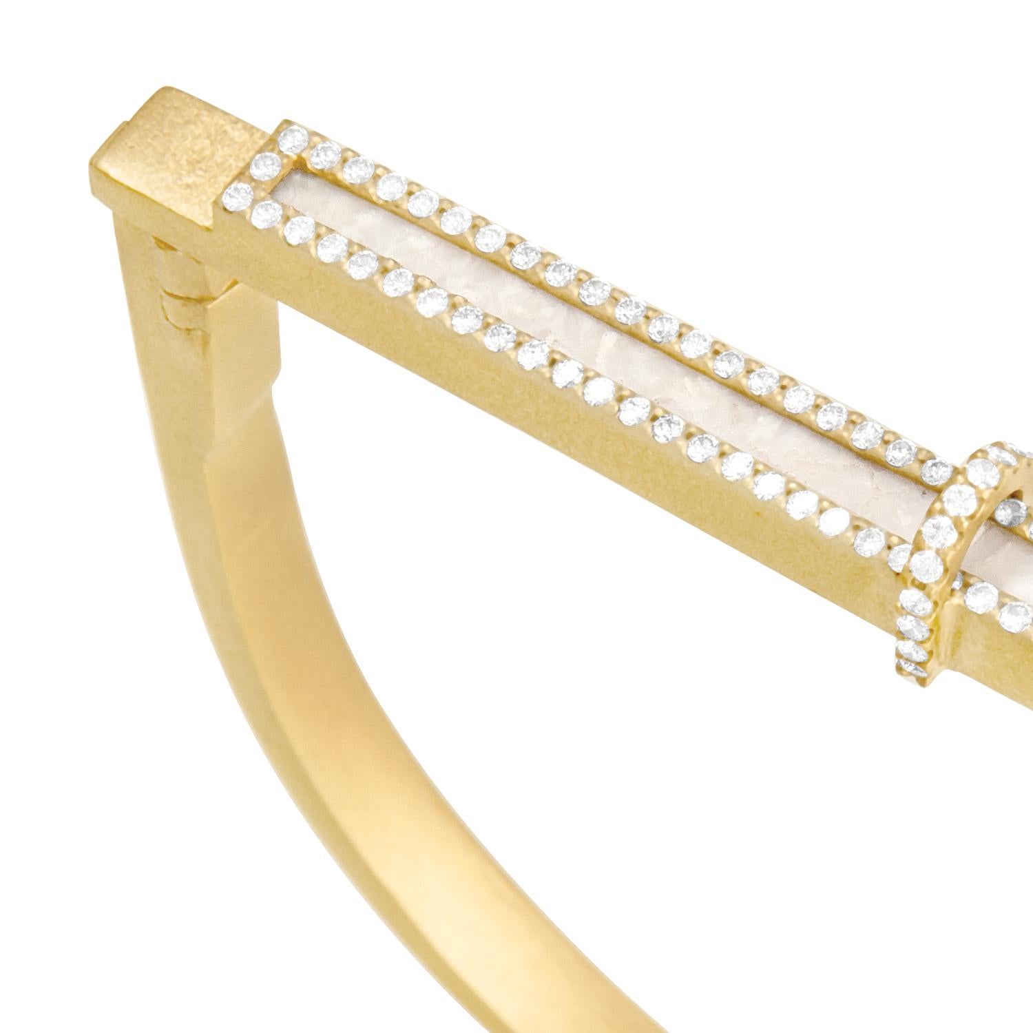 Cream fossilized dinosaur bone dimension bracelet with white diamond pavé, 18 carat recycled yellow gold, 0.29 TCW

Available by Special Order

The latitudinal axis of this 18 carat recycled yellow gold bangle is inlaid with cream fossilized