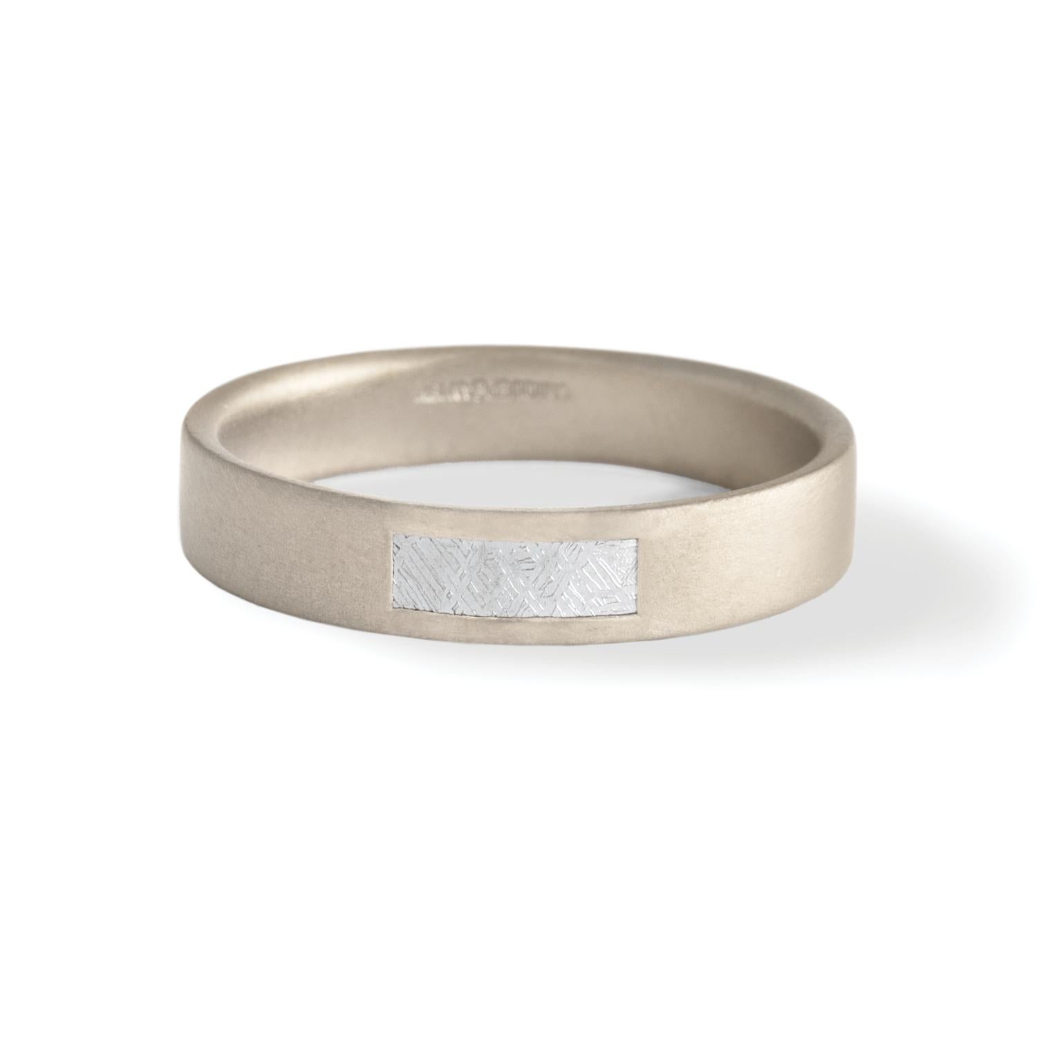 Widmanstätten pattern meteorite inlay band, 4.5mm, 18 carat recycled white gold  - One-of-a-kind

Inspired by the intersection of Earth and cosmos, this ring of 18 carat recycled white gold features a handcrafted inlay panel featuring a 4.6 billion