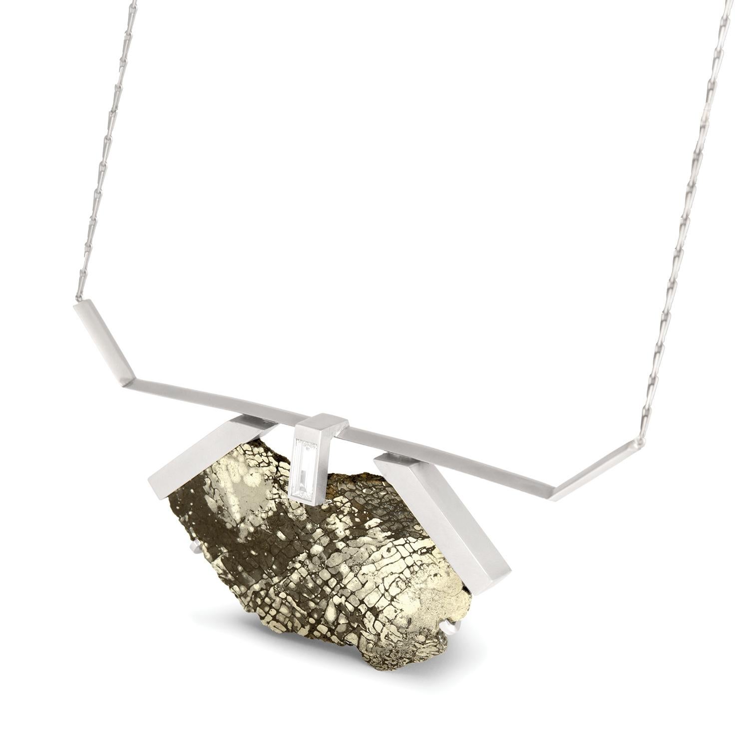 1.43 carat white rectangular step cut diamond and pyritized dinosaur bone vertebra suspension necklace, recycled platinum, 1.43 TCW  - One-of-a-kind

A natural vertebra specimen of lucent pyritized dinosaur bone with raw edges is juxtaposed against