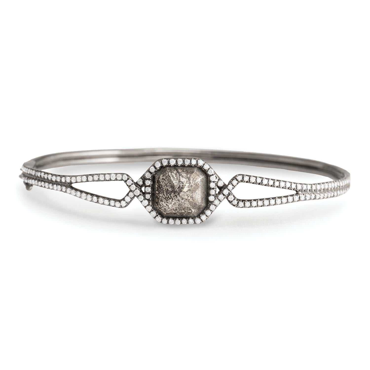 Pyritized dinosaur bone with white diamond pavé bangle bracelet, 18 carat recycled oxidized white gold, 1.64 TCW  - One-of-a-kind

A pyramid of hand carved pyritized dinosaur bone, encircled by ellipsing segments of white diamond pavé, crowns this