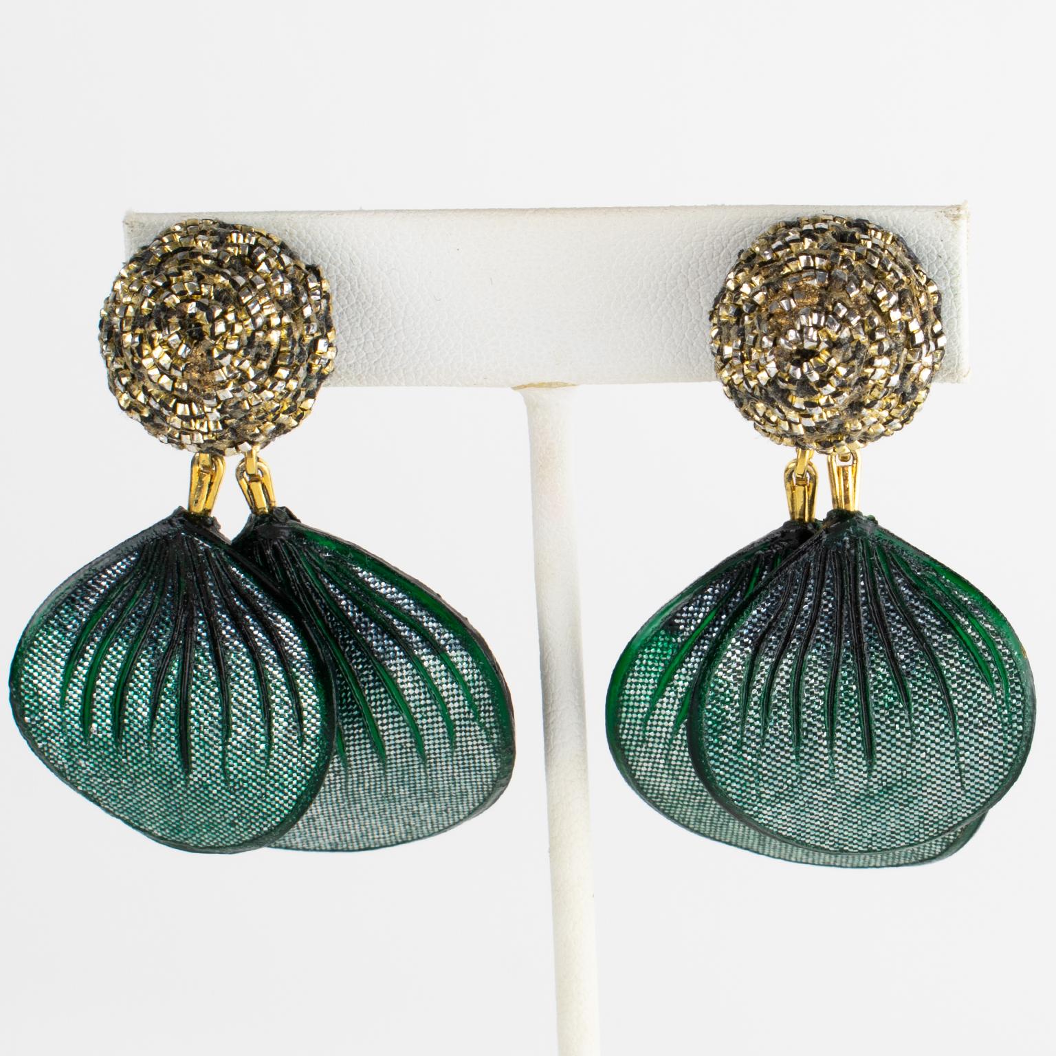 Monique Vedie Paris designed these rare Talosel resin clip-on earrings. The pieces boast a floral dangling shape with carved, dimensional, large petal drops in emerald green color with glittering textured pattern. The fastenings feature domed black