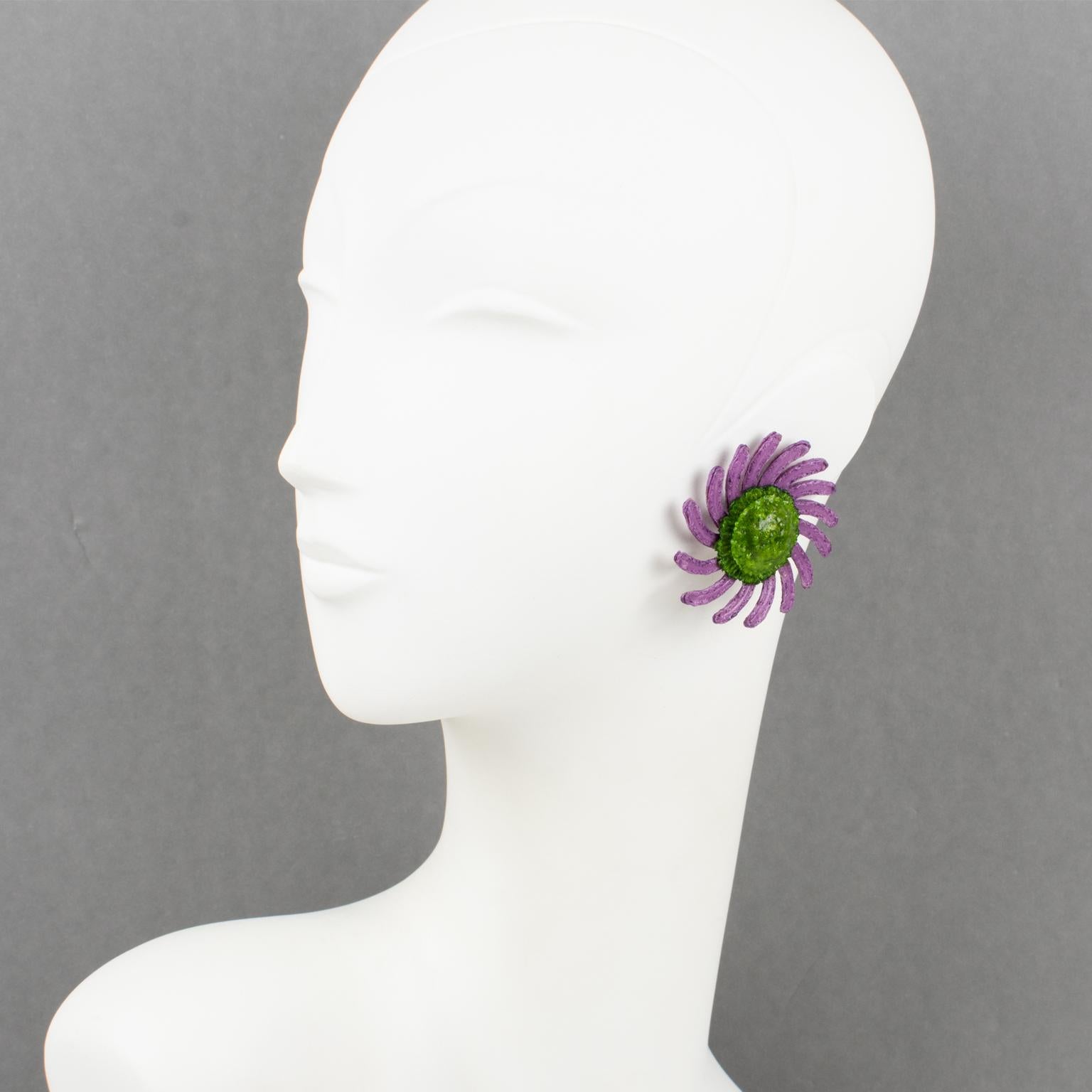 These elegant Monique Vedie resin or Talosel clip-on earrings feature a daisy flower shape in a carved dimensional design with a textured pattern in pearlized lavender purple color contrasted with an avocado green textured heart. They are the