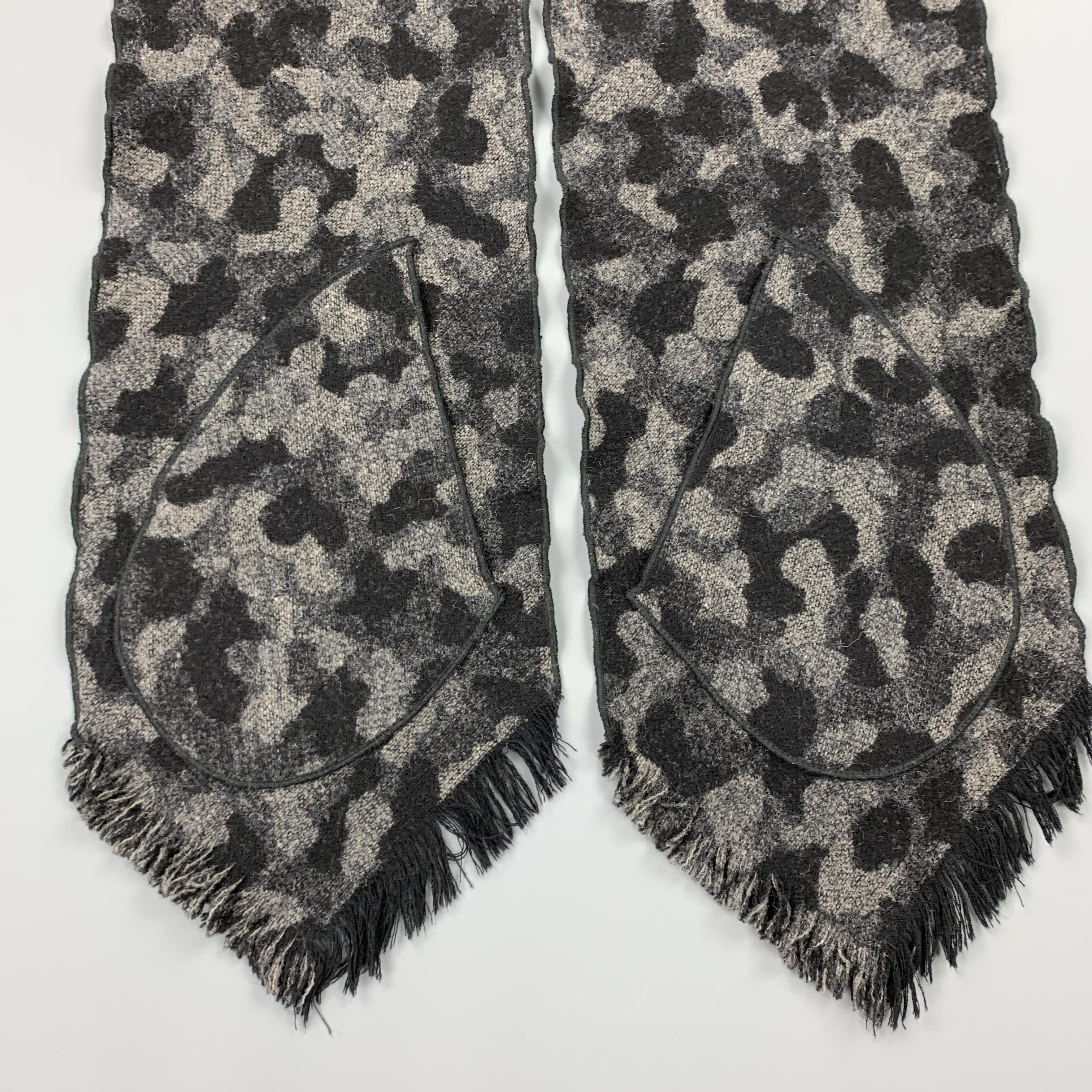 MONITALY scarf comes in grayscale camouflage wool with patch pockets and fringe edges. 

Excellent Pre-Owned Condition.

Length: 66 in.
Width: 9.5 in.