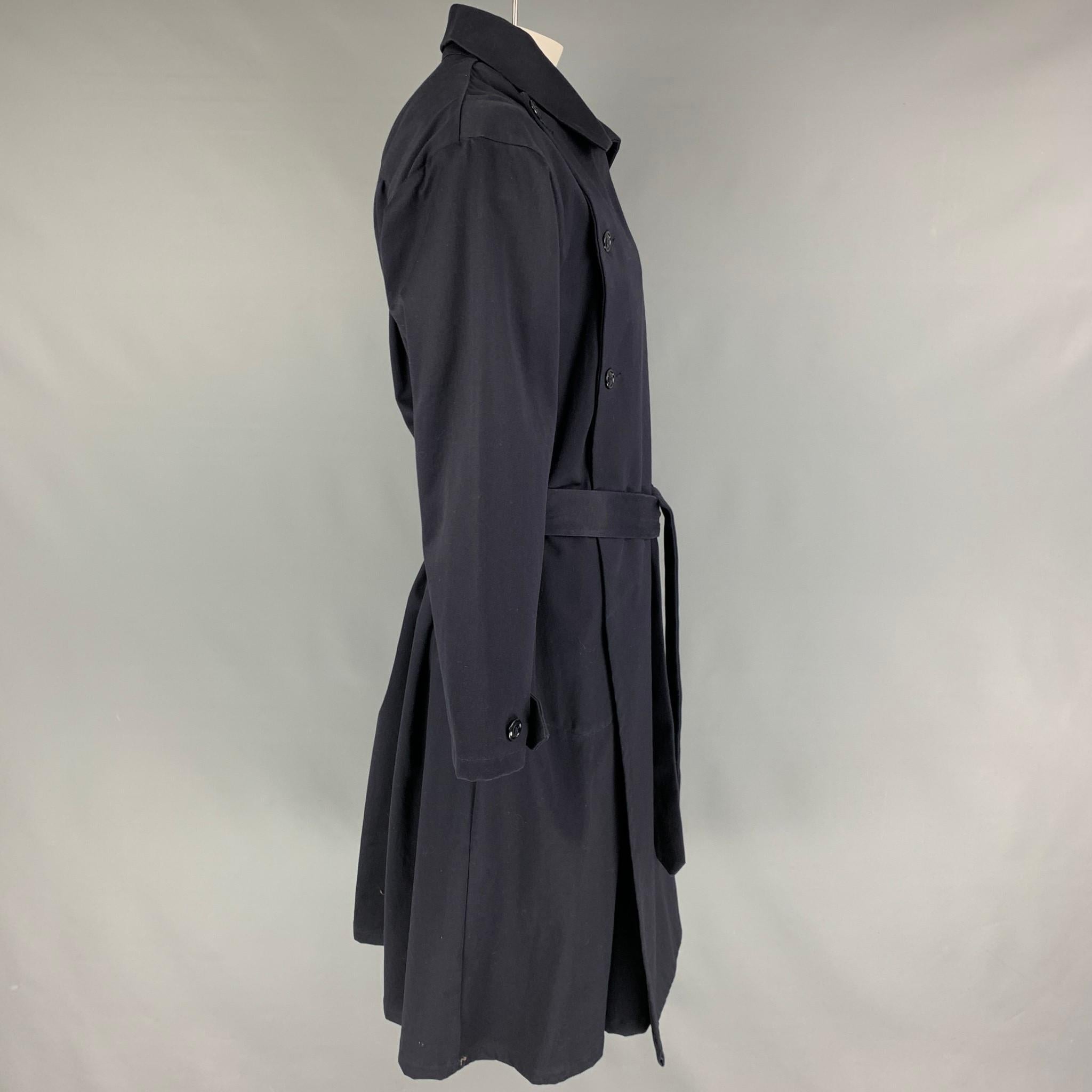 MONITALY coat comes in a water resistant navy sateen material featuring a belted style, slit pockets, anda double breasted closure. Made in USA. 

Very Good Pre-Owned Condition.
Marked: 40

Measurements:

Shoulder: 21 in.
Chest: 40 in.
Sleeve: 24