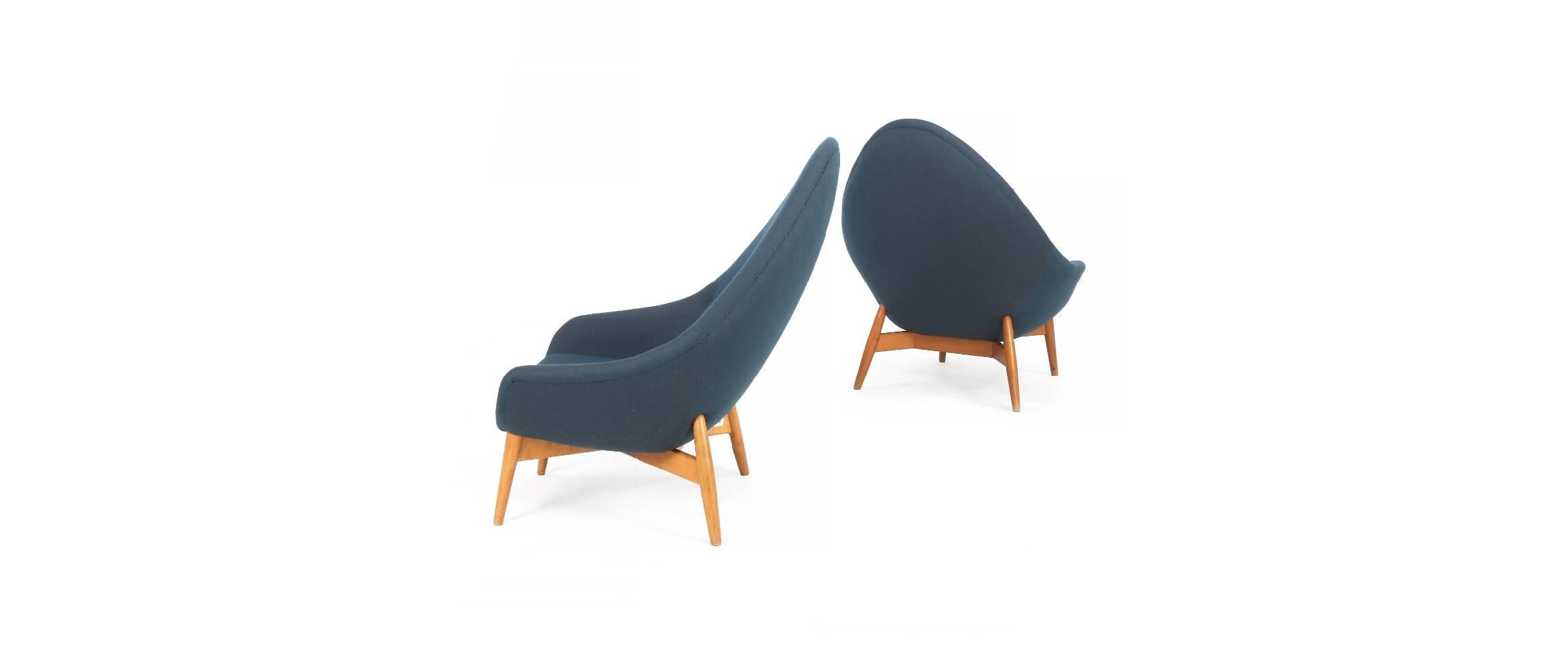 “Monk”. A pair of easy chairs with oblique beech legs and frame. Sides, back and loose seat cushion upholstered with blue wool, back fitted with buttons. These examples manufactured approx. 1950s by Keravan Puusepäntehdas/Stockmann Oy, Finland.