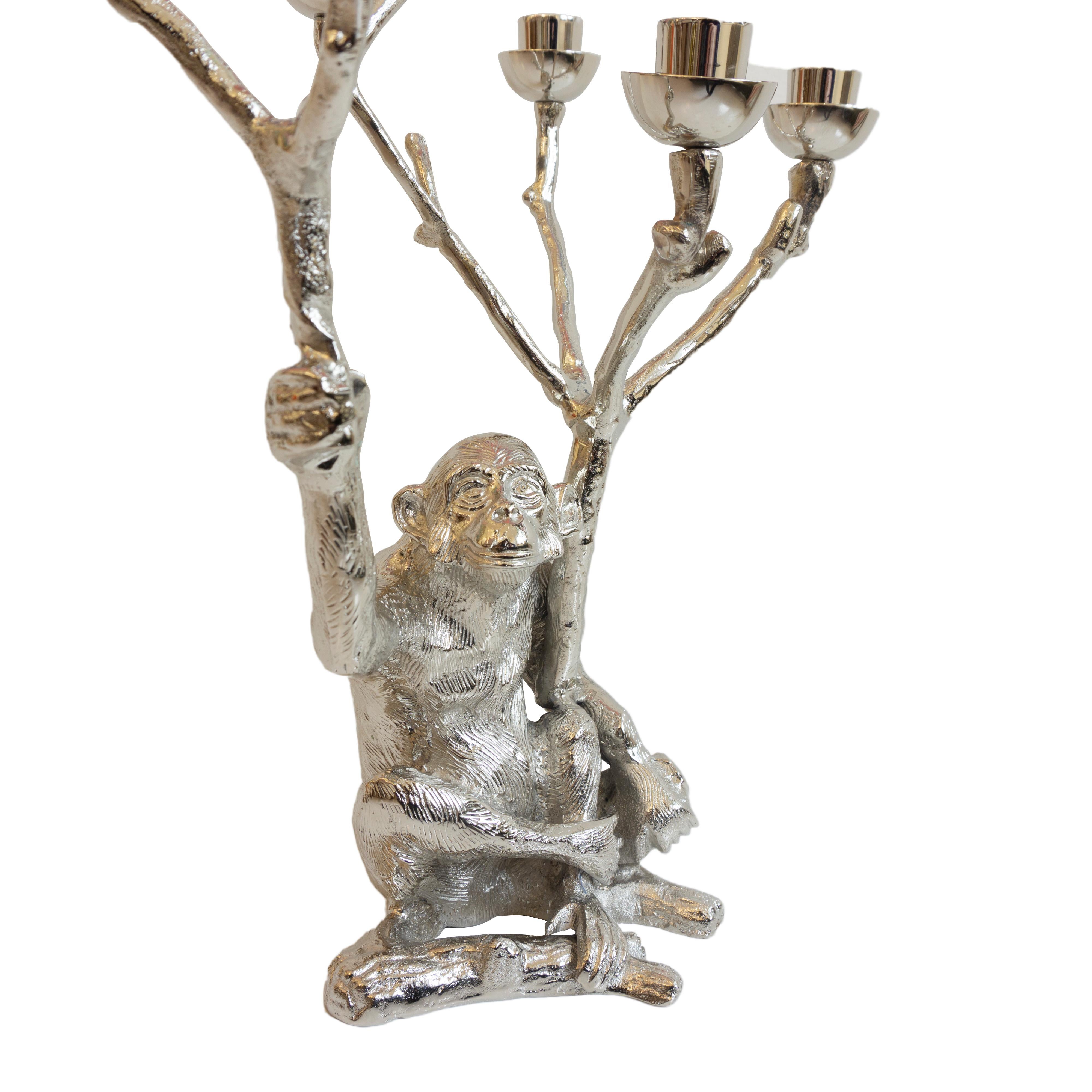 This metal candleholder with a nickel plated finish features a monkey holding two branches. Fits seven tapered candles. 

Dimensions: 16” height x 12” diameter.

   