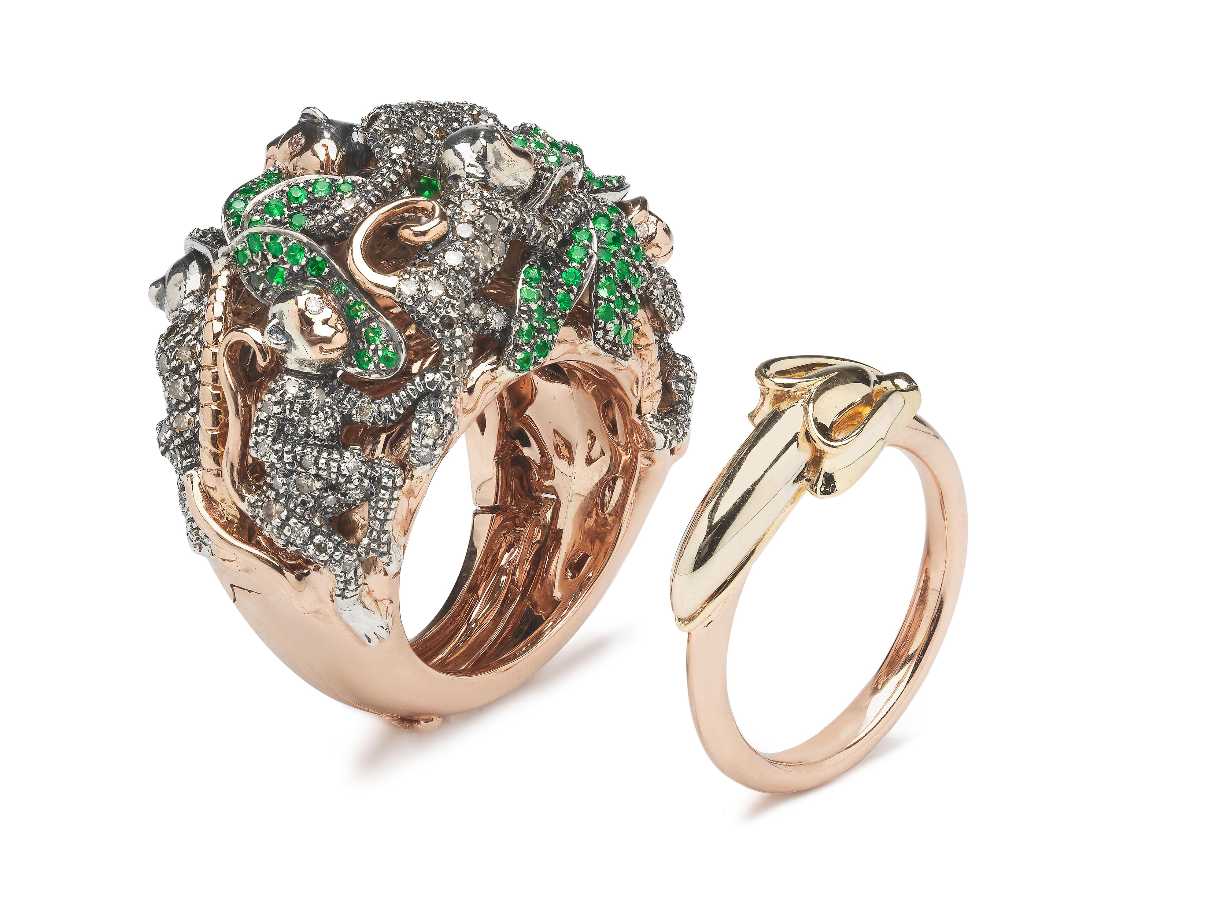 

A family of jewelled monkeys scamper around a lush jungle in this ornate cocktail ring, which makes a stunning statement piece. The ring is designed in 18k rose gold and yellow gold and set with sterling silver and rose gold monkeys, embellished