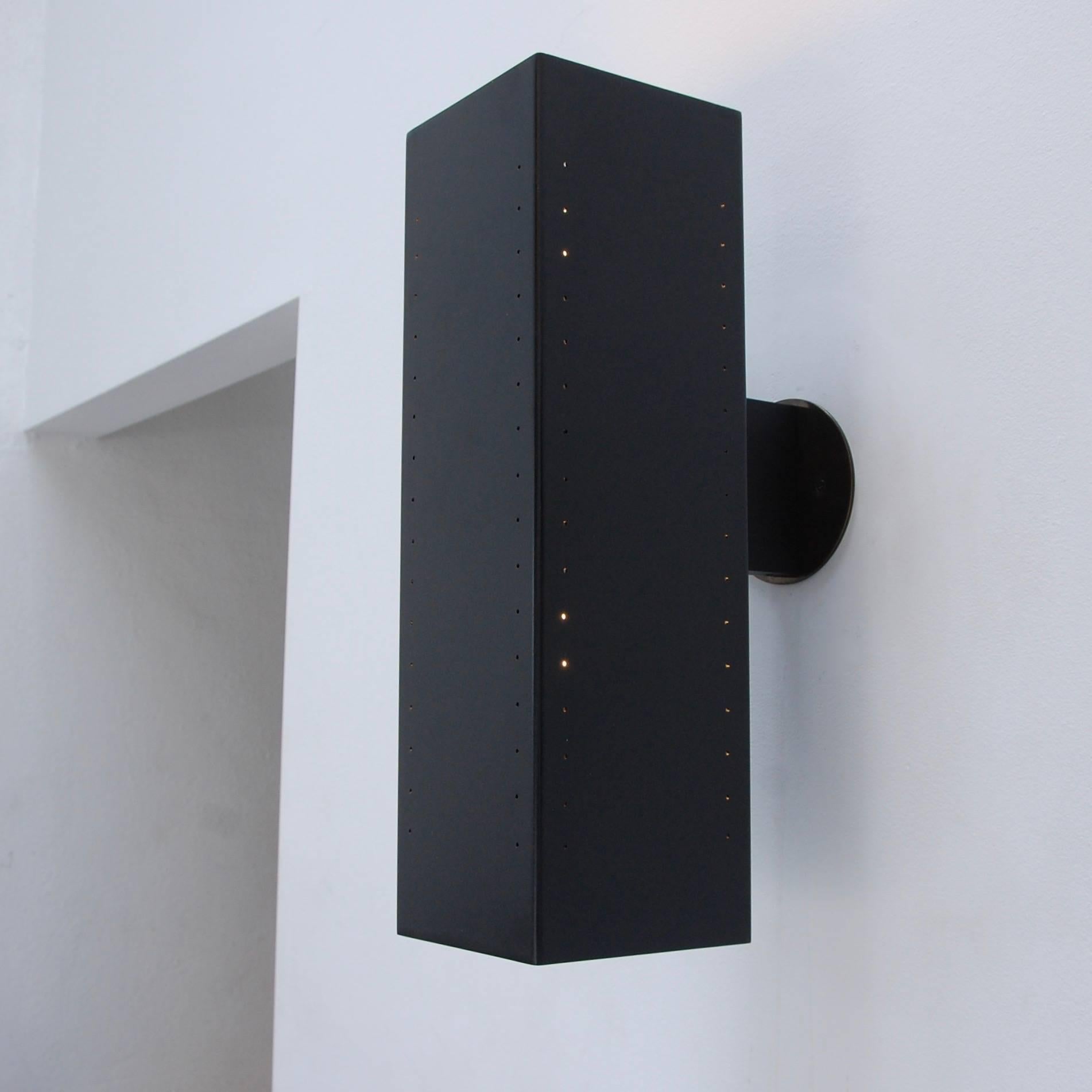 Part of Lumfardo Luminaire’s contemporary collection the Lulith outdoor sconce is a large rectangular perforated sconce in painted black aluminium, steel and brass. Lamped with two E26 medium based sockets per sconce. Shade dimensions are 6” x 6”