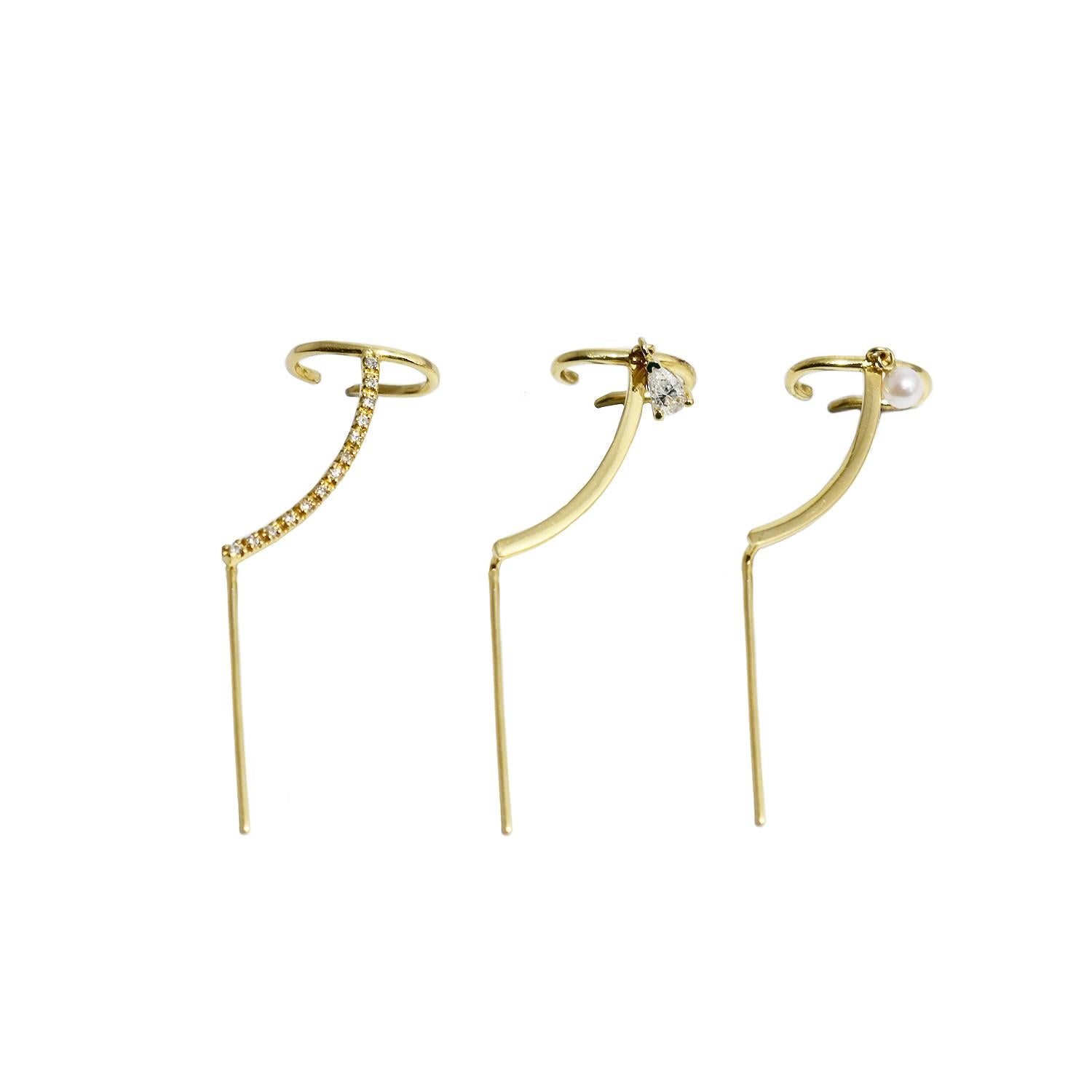 The Mono Cuff Needle Gold Earring is a statement earring in solid 14k gold. It subtle curve follows the outline of your ear finishing in a comfortable cuff. 

How to wear it: 

Thread the needle end of the earring through the ear lobe piercing and