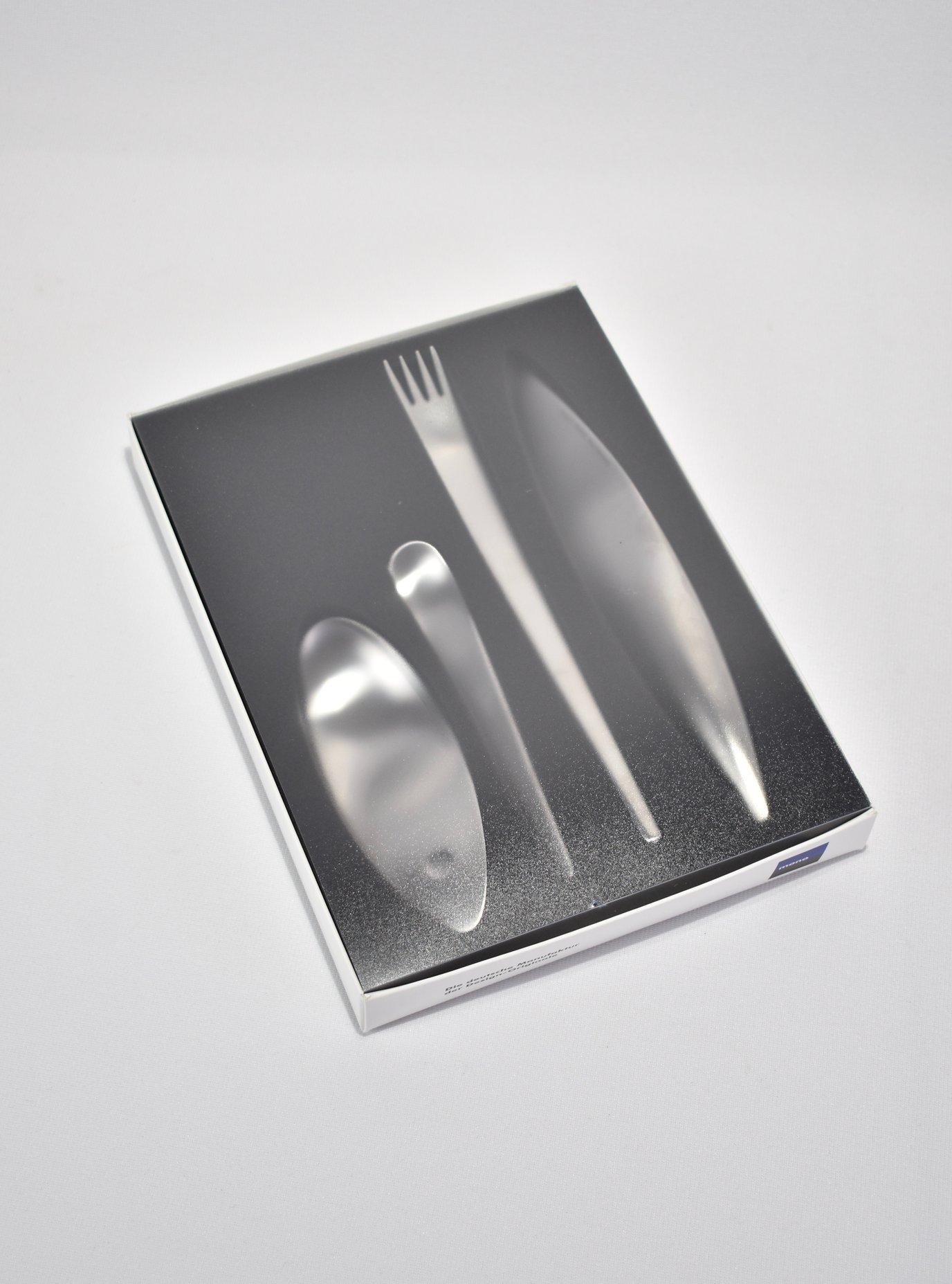 Stunning 4-piece flatware set designed to inspire a primal dining experience. The hand ax inspired the knife, the elongated fork is reminiscent of early skewing tools, and the spoon recalls a cupping hand. Designed by Michael Schneider in 1995, the