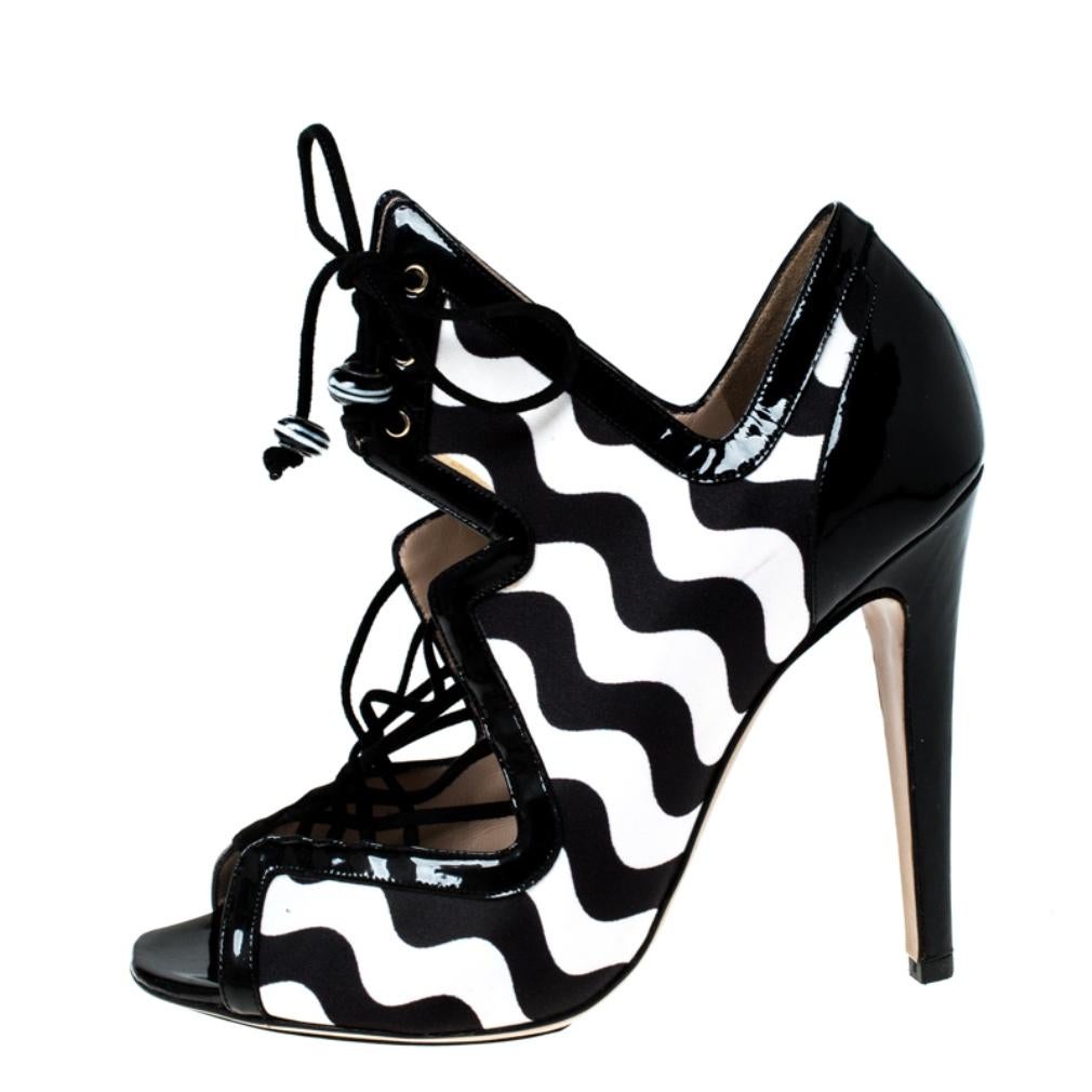 Wear these satin and patent leather sandals when you go out and watch heads turn. This fashionable footwear from Nicholas Kirkwood can give your entire ensemble a makeover. Featuring a strappy style and high heels, this monochrome pair is