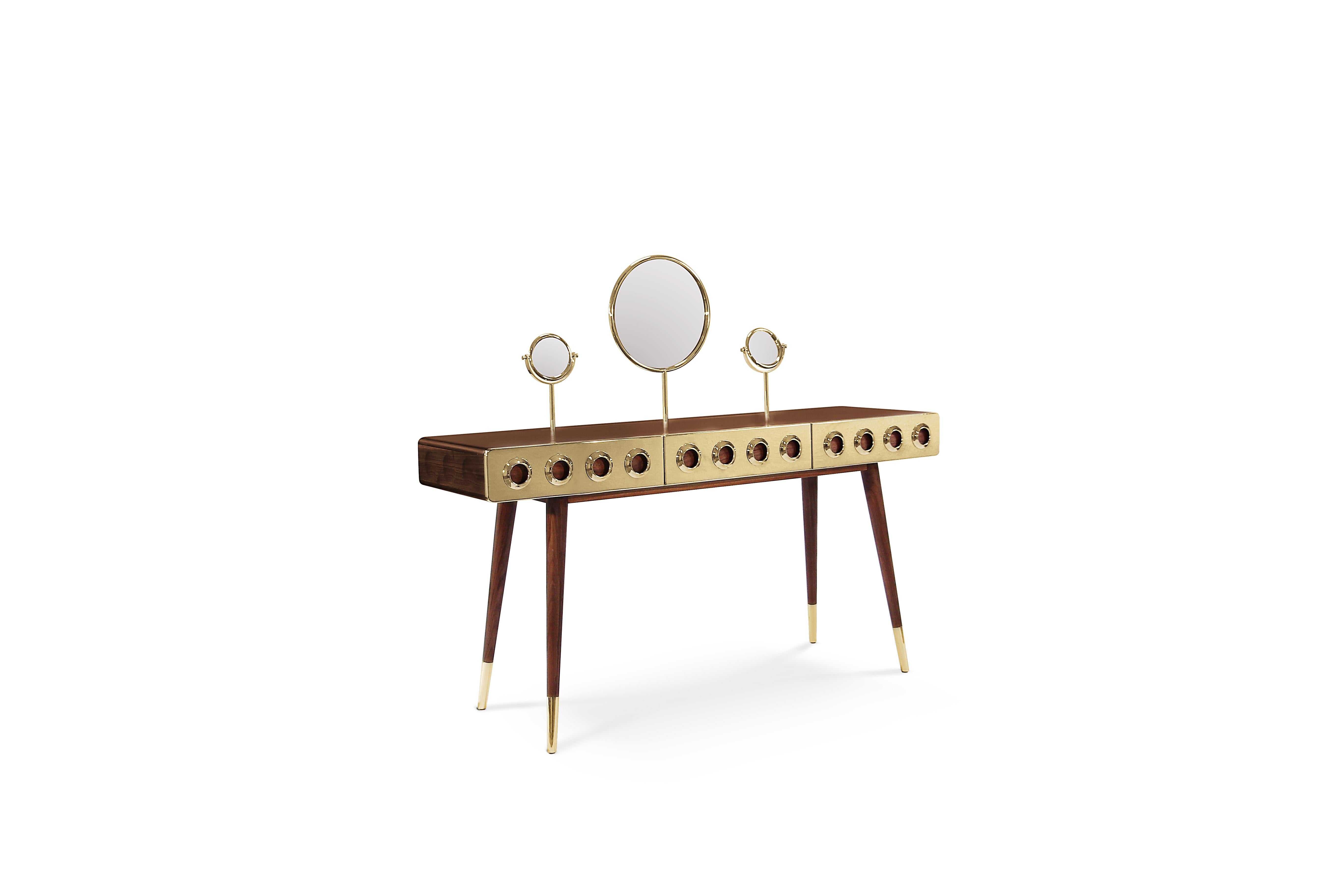 The ultimate dressing table is the ultimate gadget every mid‐century modern sleek interior should have. Golden brass drawers and engraved circles in the solid walnut body are its trademarks, as well as the gold plated feet. A large front mirror fits