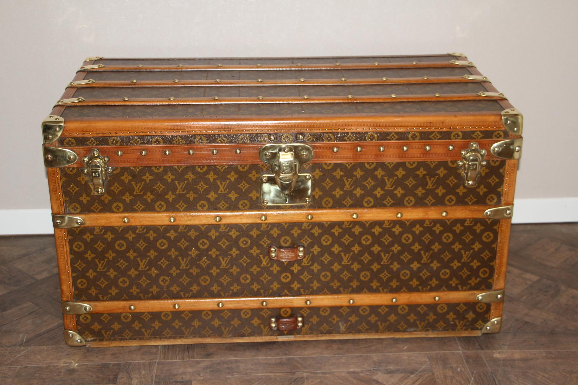 This beautiful Louis Vuitton trunk is all stenciled LV monogram canvas, with all Louis Vuitton stamped brass hardware and lozine trim. It features large leather side handles as well as customized painted French flag on each side. It has got a very