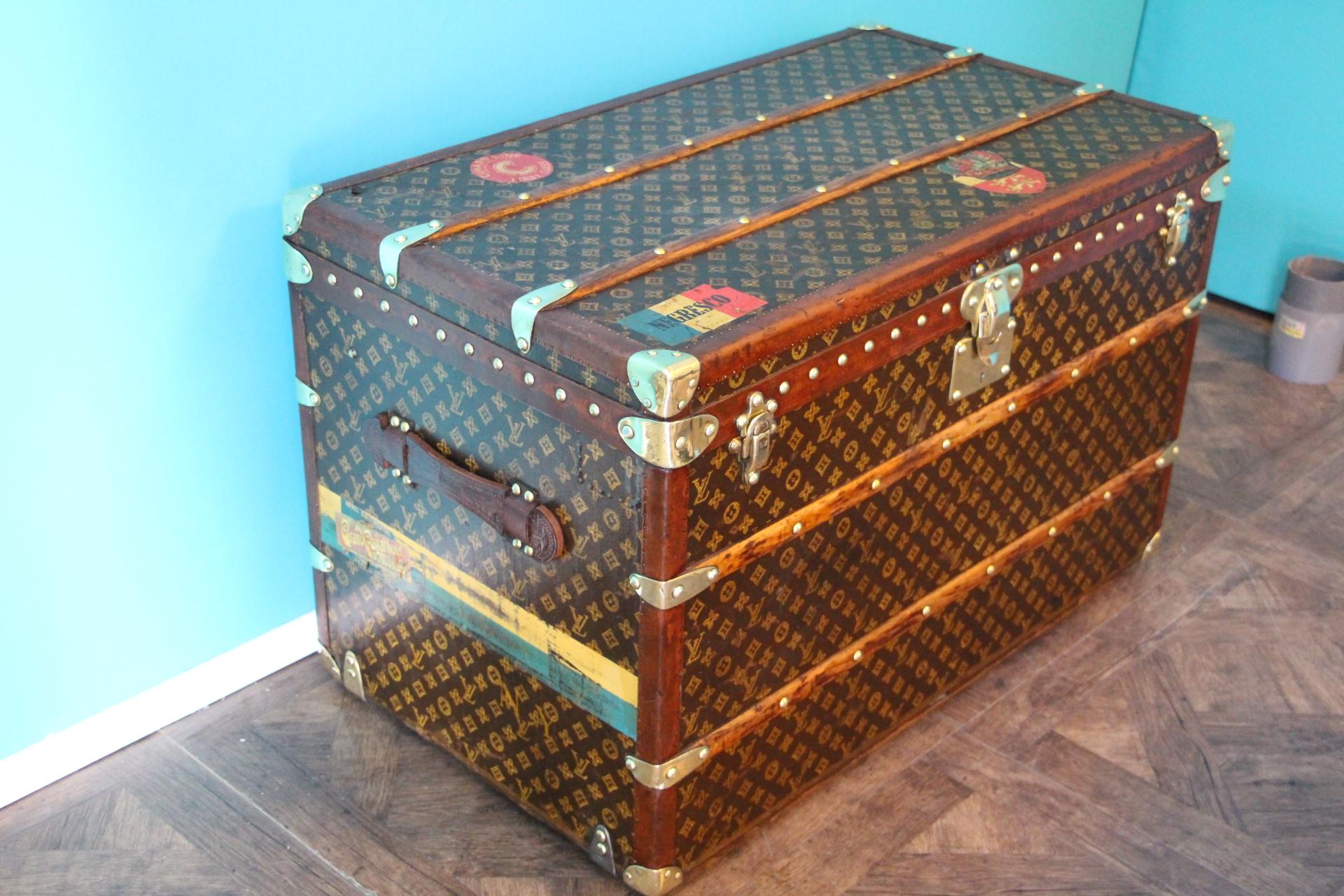 This beautiful Louis Vuitton trunk is all stenciled LV monogram canvas, with all Louis Vuitton stamped brass hardware and lozine trim. It features large leather side handles as well as customized painted stripes on each side as well as couple of