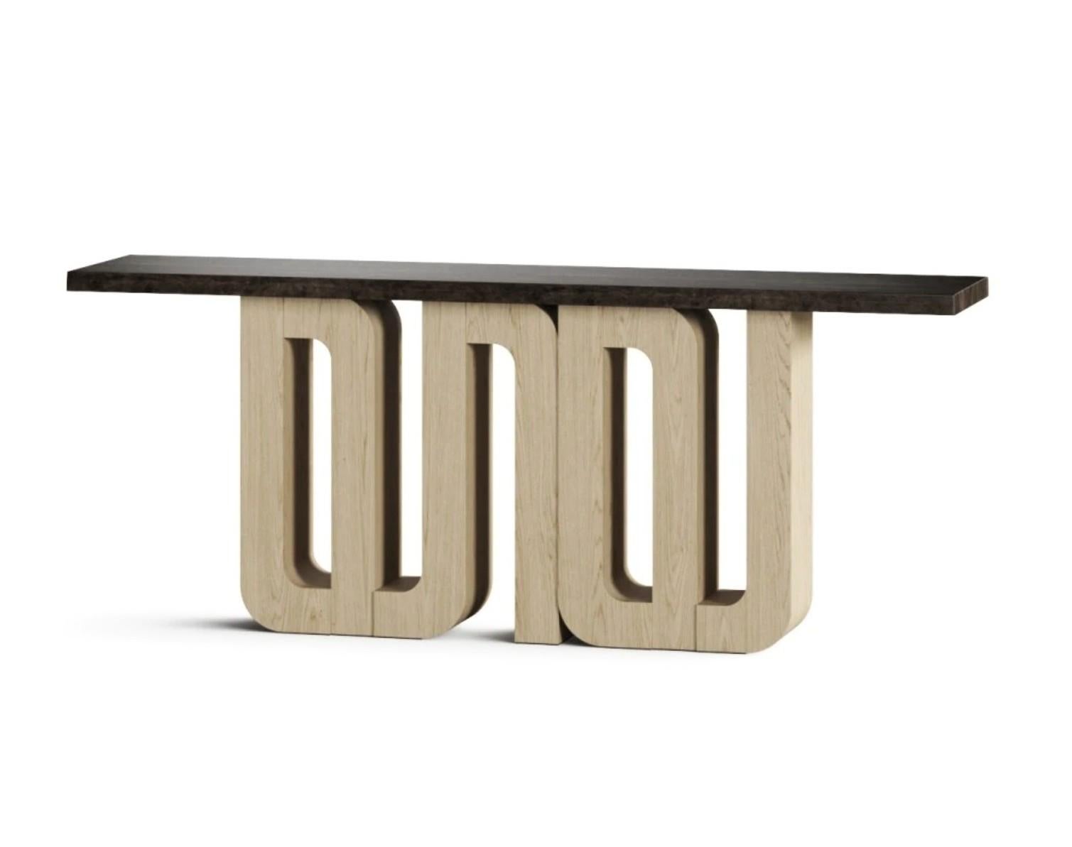 This modern and elegant console table is a beautiful combination of natural materials. The expansive top is crafted from Macassar stone, which is given a brilliant, polished finish to highlight its unique patterns and natural luster. The table's
