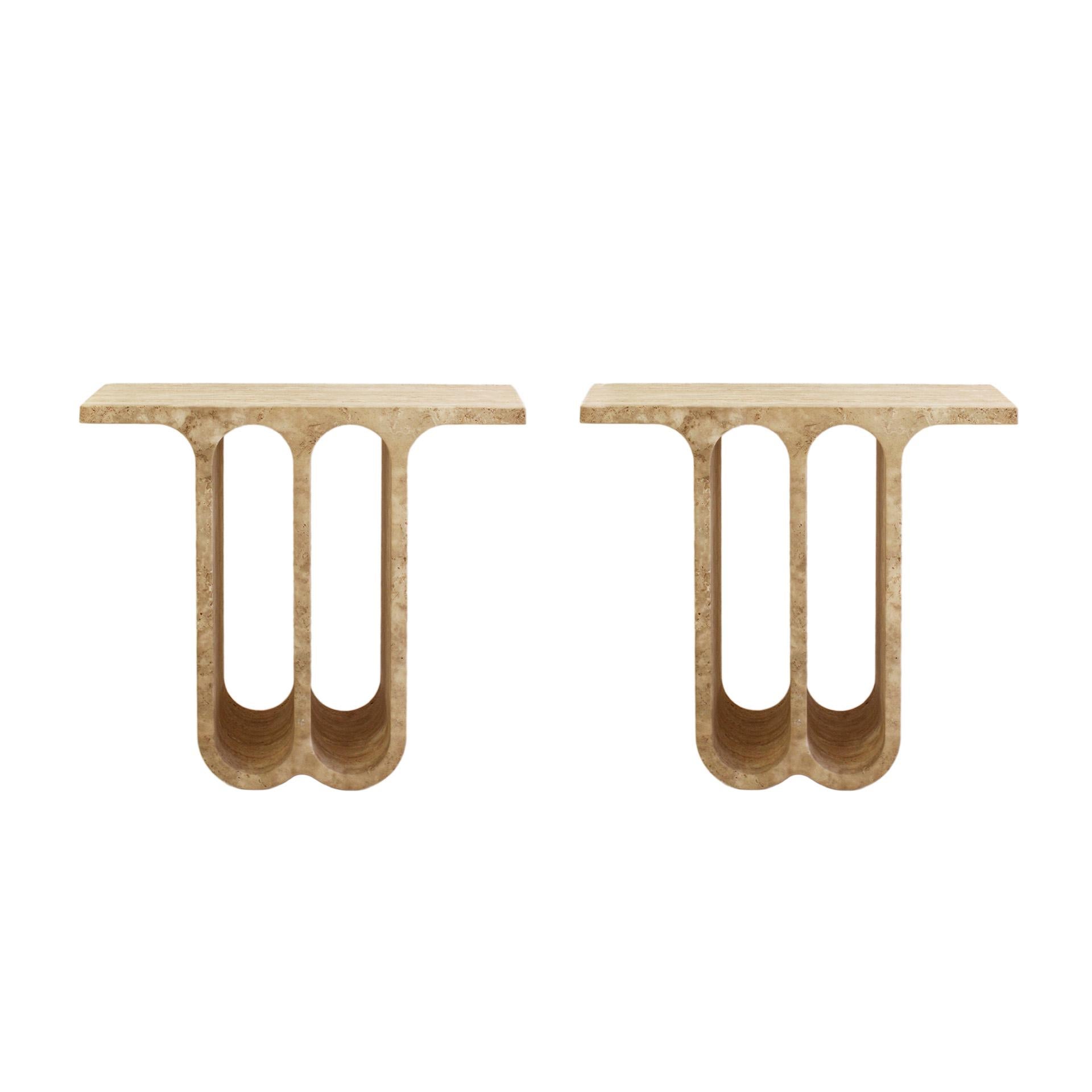 Pair of Travertine Consoles. Made from a single block of stone, featuring a sculptural and contemporary design through the use of semi-circular arches.

These consoles have been meticulously crafted from a single block of natural stone, ensuring