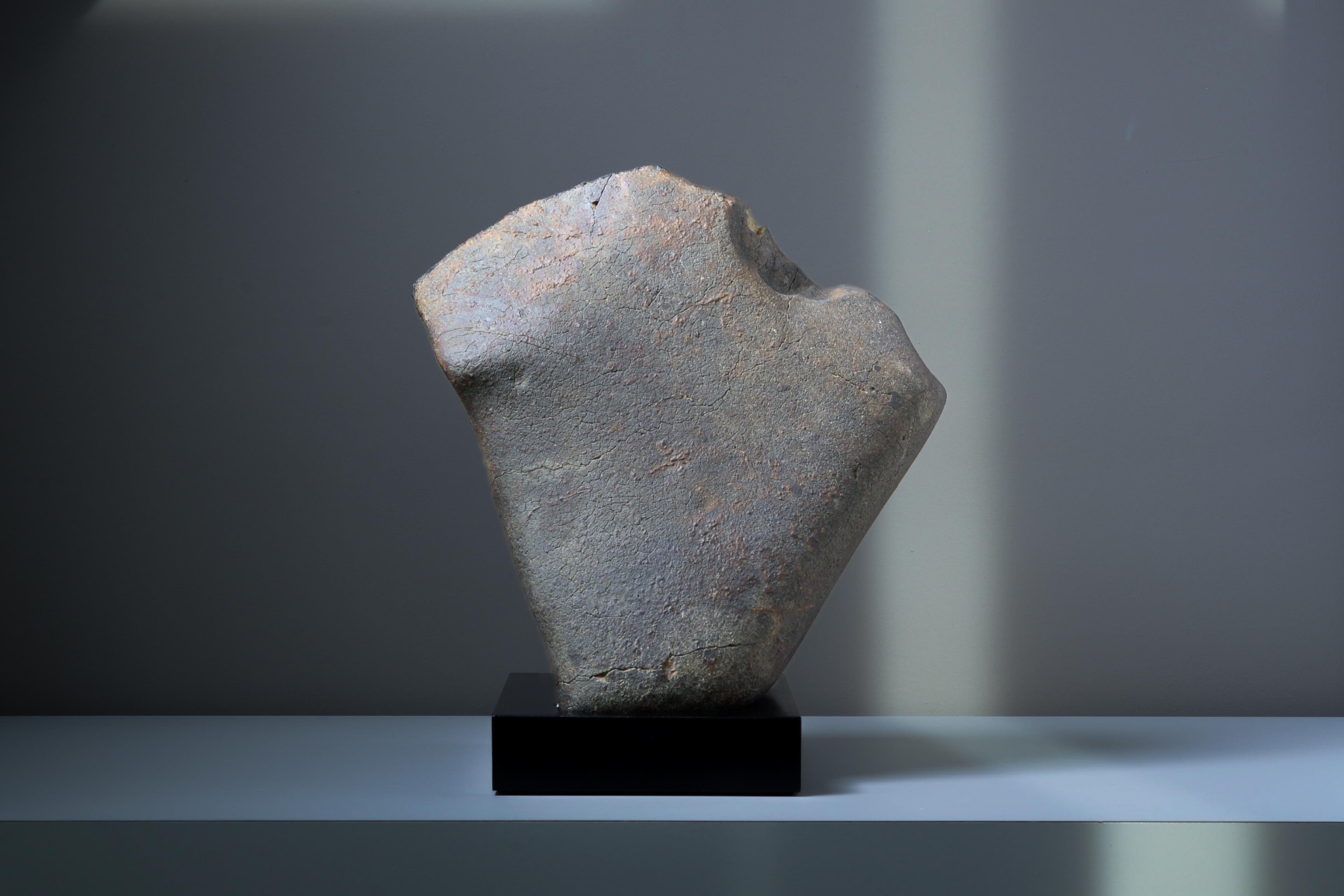 This remarkable stony meteorite is a striking extraterrestrial sculpture, shaped by its journey through space. Almost monolithic in form, its minimal aesthetic gives it striking similarities to contemporary artwork. But, formed in the asteroid belt