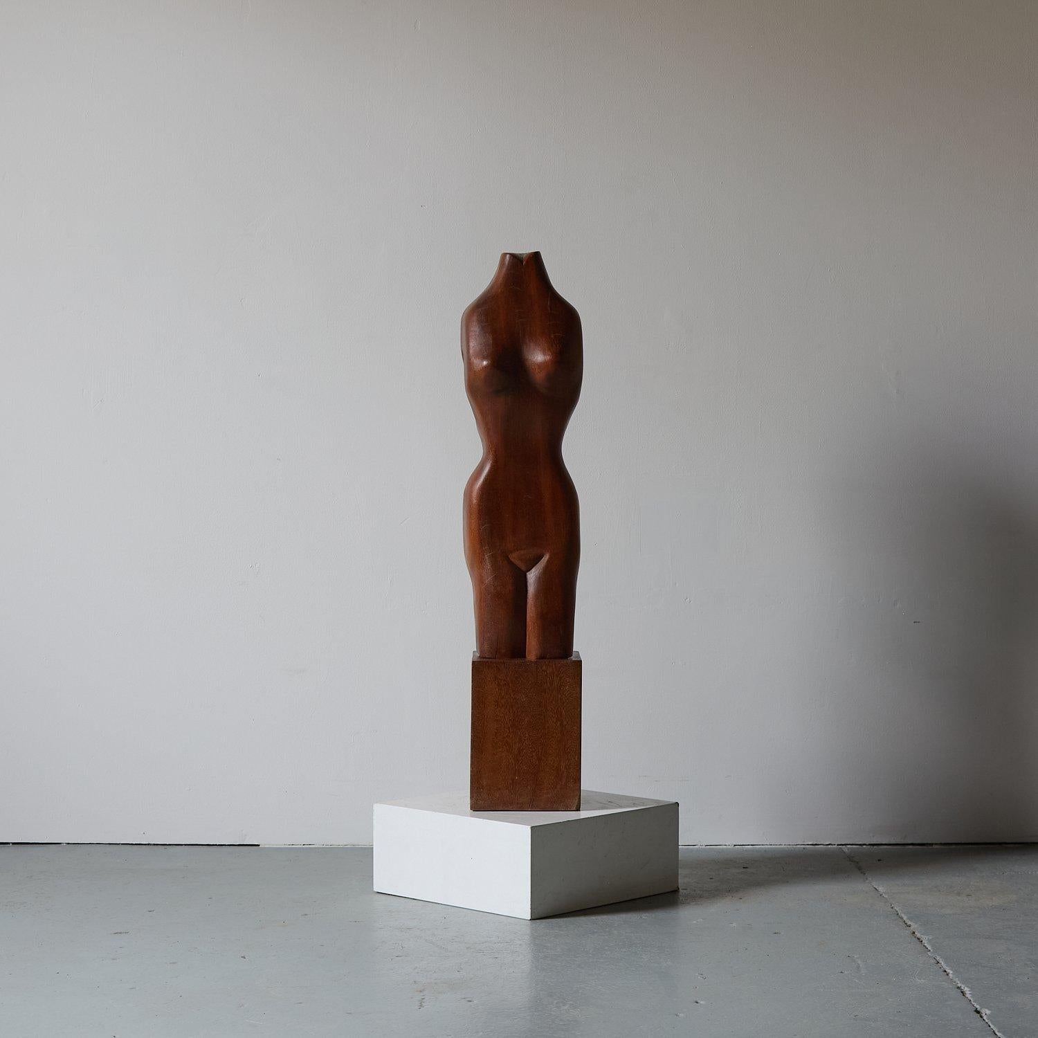 Beautiful study of Venus, direct carved into solid afromosia. It shows a stylized and simplified female torso, focusing on the flow and curves of the human form rather than on realistic anatomical detail.

The smooth, organic shapes and the polished