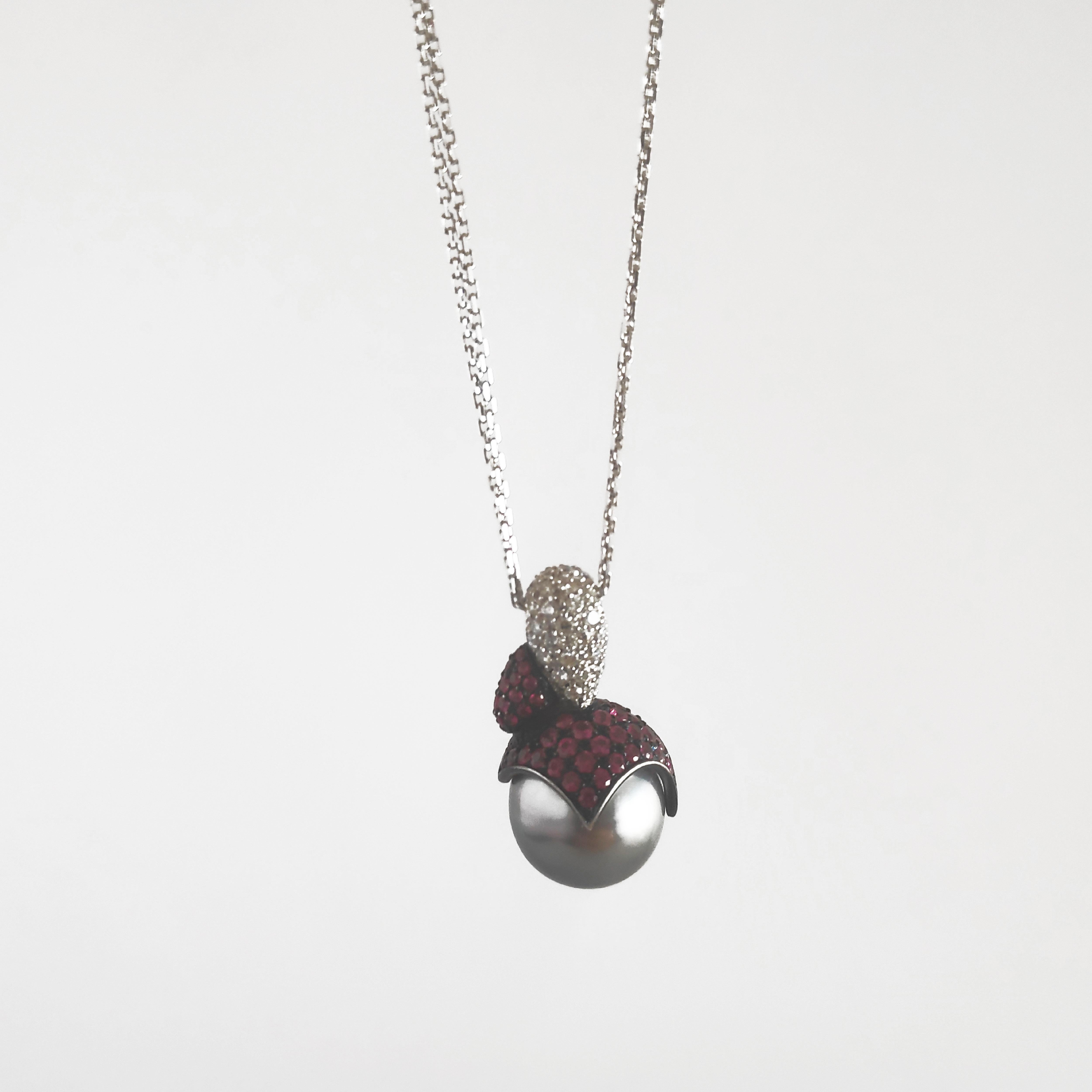 This pendant necklace is handcrafted in white 19.2K gold with a beautiful Tahitian Cultured Pearl and set with white diamonds and rubies. This piece is designed by Monseo and manufactured by Monseo artisans in Porto, Portugal.                       