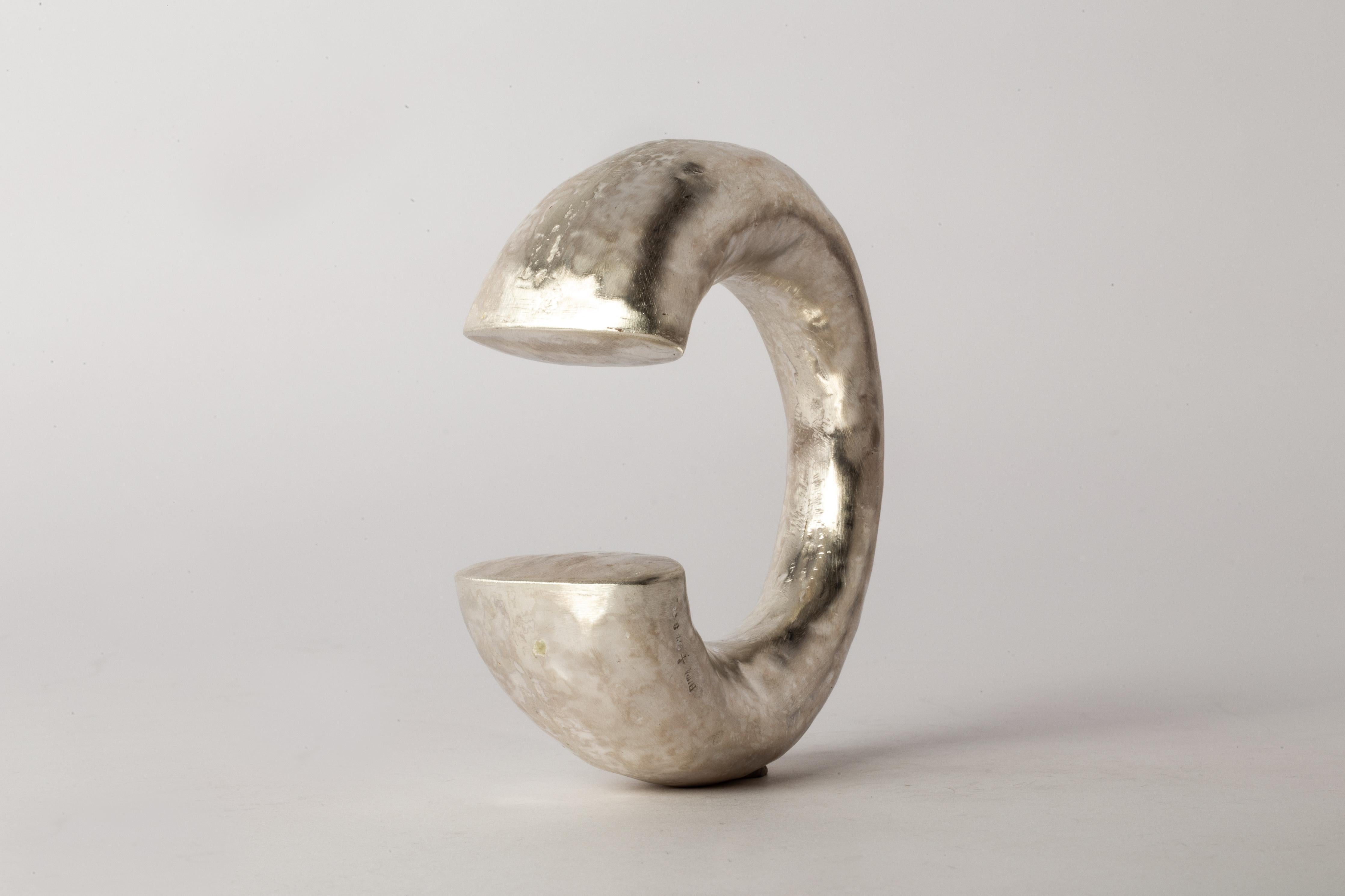 Bracelet in matte sterling silver. This piece is 100% hand fabricated from metal plate; cut into sections and soldered together to make the hollow three dimensional form. If sterling silver, the sheet metal is made by hand. The silver is melted and