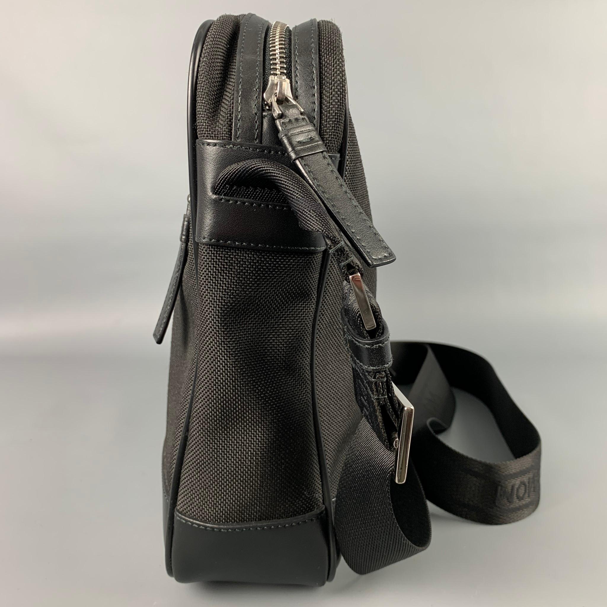 MONT BLANC briefcase comes in a black canvas with a leather trim, silver tone hardware, shoulder strap, front zipper pocket, inner slots, ad a zipper closure. Made in Italy.  

Very Good Pre-Owned Condition.

Measurements:

Length: 13.5 in.
Width: 3