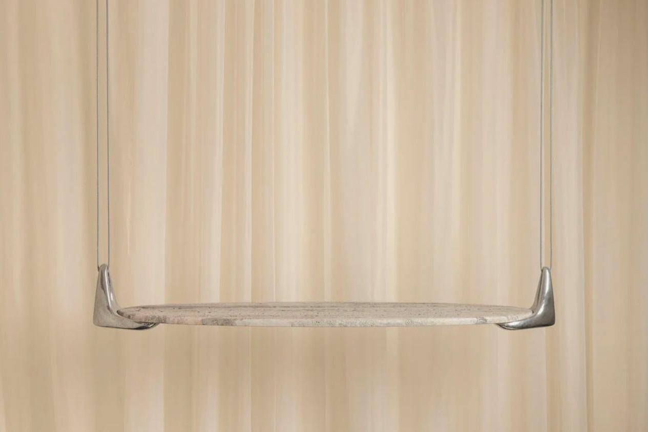 “Montacargas” by RIO Estudio is a marble shelf with cast aluminum fittings, held in place by a suspension mechanism. This creation is a testament to the engineering roots of its founder, Patricio Robleda, who studied civil engineering at UNAM. The