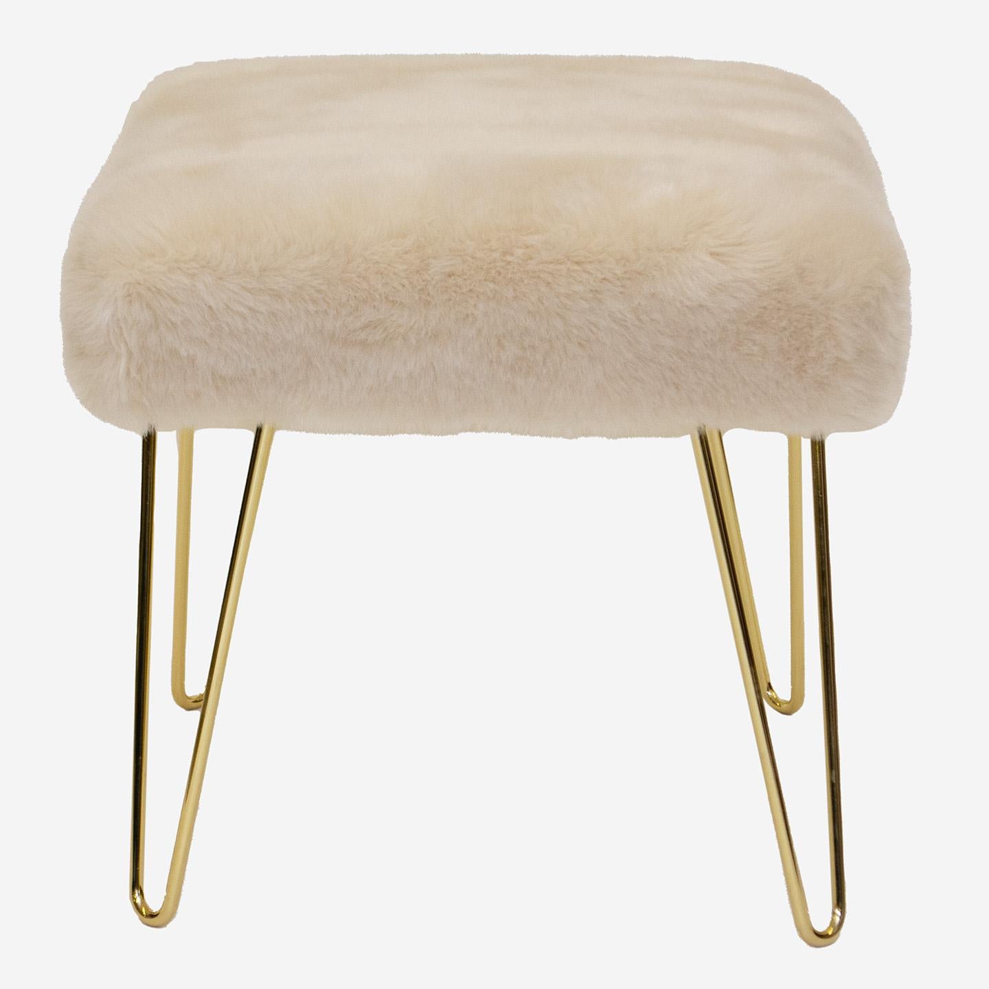 The perfect addition to any space! Wonderfully proportioned pair of ottomans upholstered in a cream colored faux fur. These work in a multitude of spaces: in a living space, under a console, at the foot of a bed. Think of anywhere you need an accent