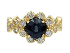 Montana Blue Sapphire and Diamond Halo Flower Motif Ring in 14 Karat Yellow Gold