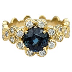 Montana Blue Sapphire and Diamond Halo Flower Motif Ring in 14 Karat Yellow Gold