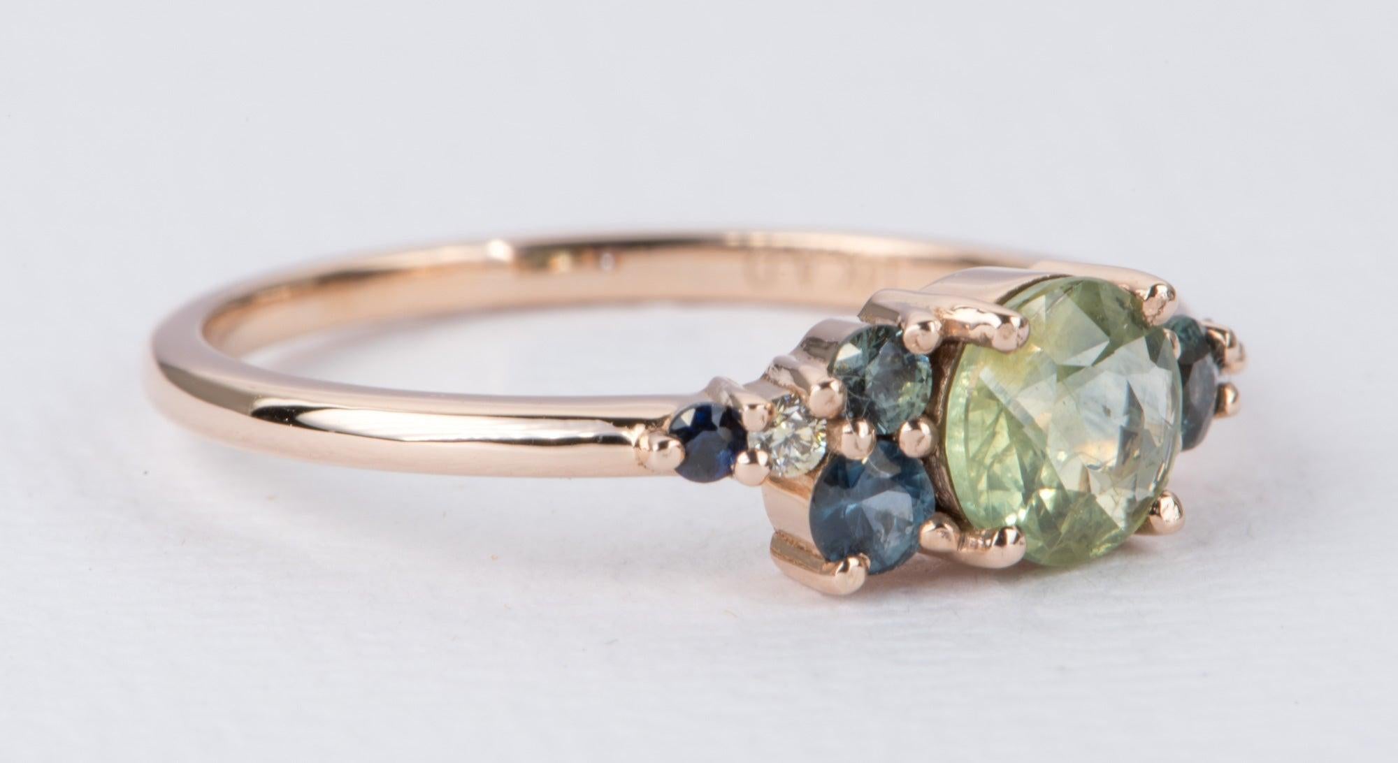 ♥ This is a unique ring set with a round-shape parti-color Montana sapphire in the center, flanked by additional sapphires and diamonds on the sides
♥ Low-profile ring setting

♥ Material: 14K rose gold
♥ Ring size: US 6.5 (Free resizing up or down