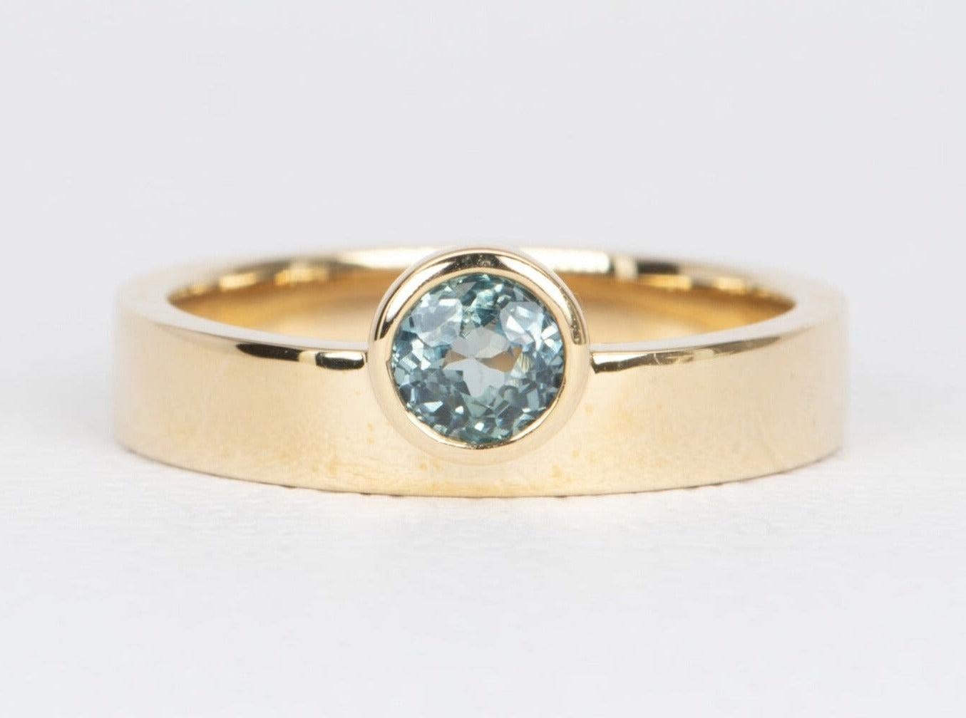 ♥ Solid 14K yellow gold ring set with a round Montana sapphire in a bezel setting
♥ The overall setting measures 7.1 mm in width, 6 mm in length, and sits 4.3 mm tall from the finger

♥ Ring size: US Size 7 (Free resizing up or down one size)
♥ Band