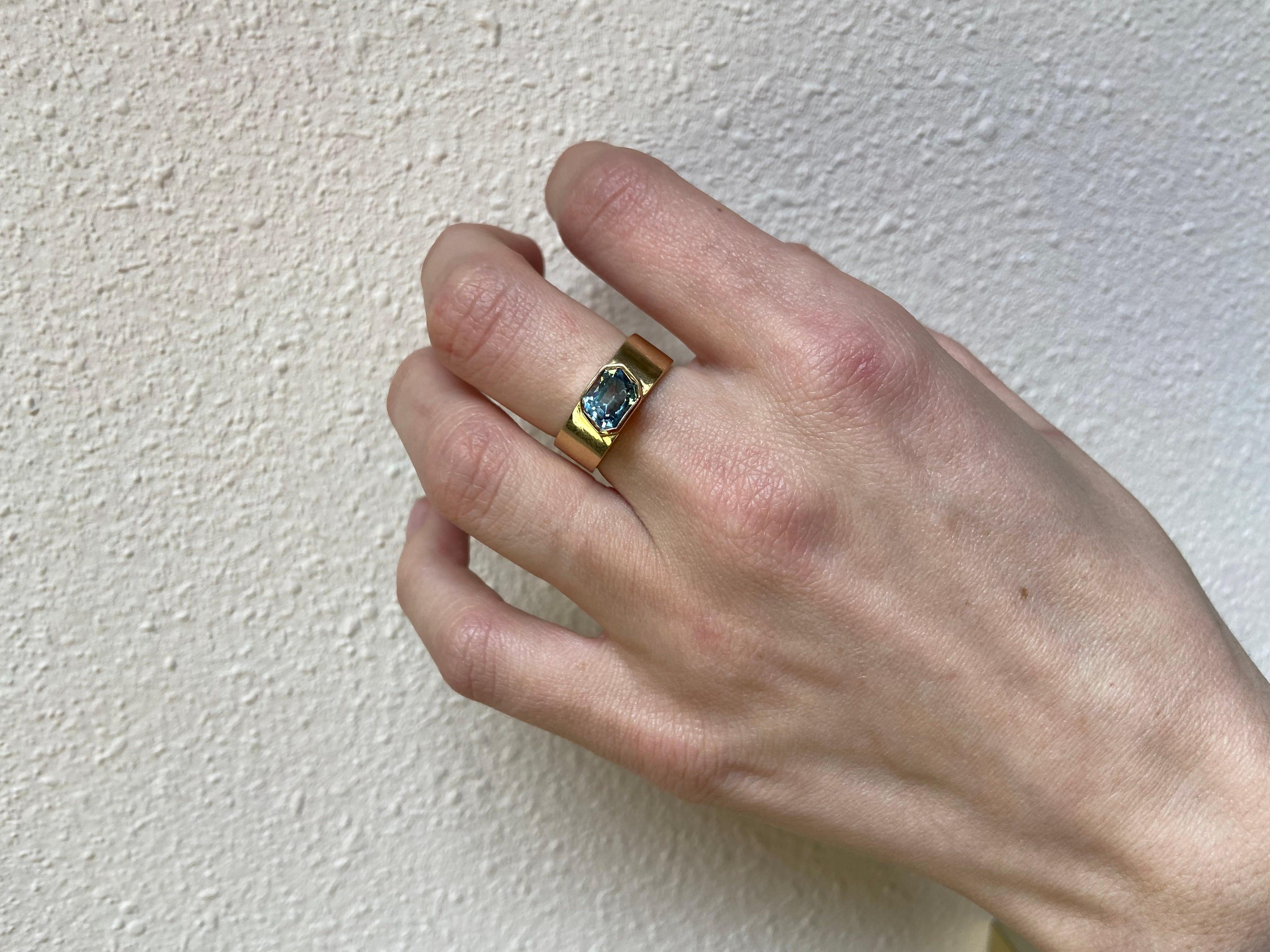 This bespoke ring is so beautiful and unique, we cannot wait until we find the ring's forever home. Made with a one of a kind, rare-cut Montana Blue Sapphire. Not only is this a rare stone, but the cut is one of a kind. This emerald step cut stone
