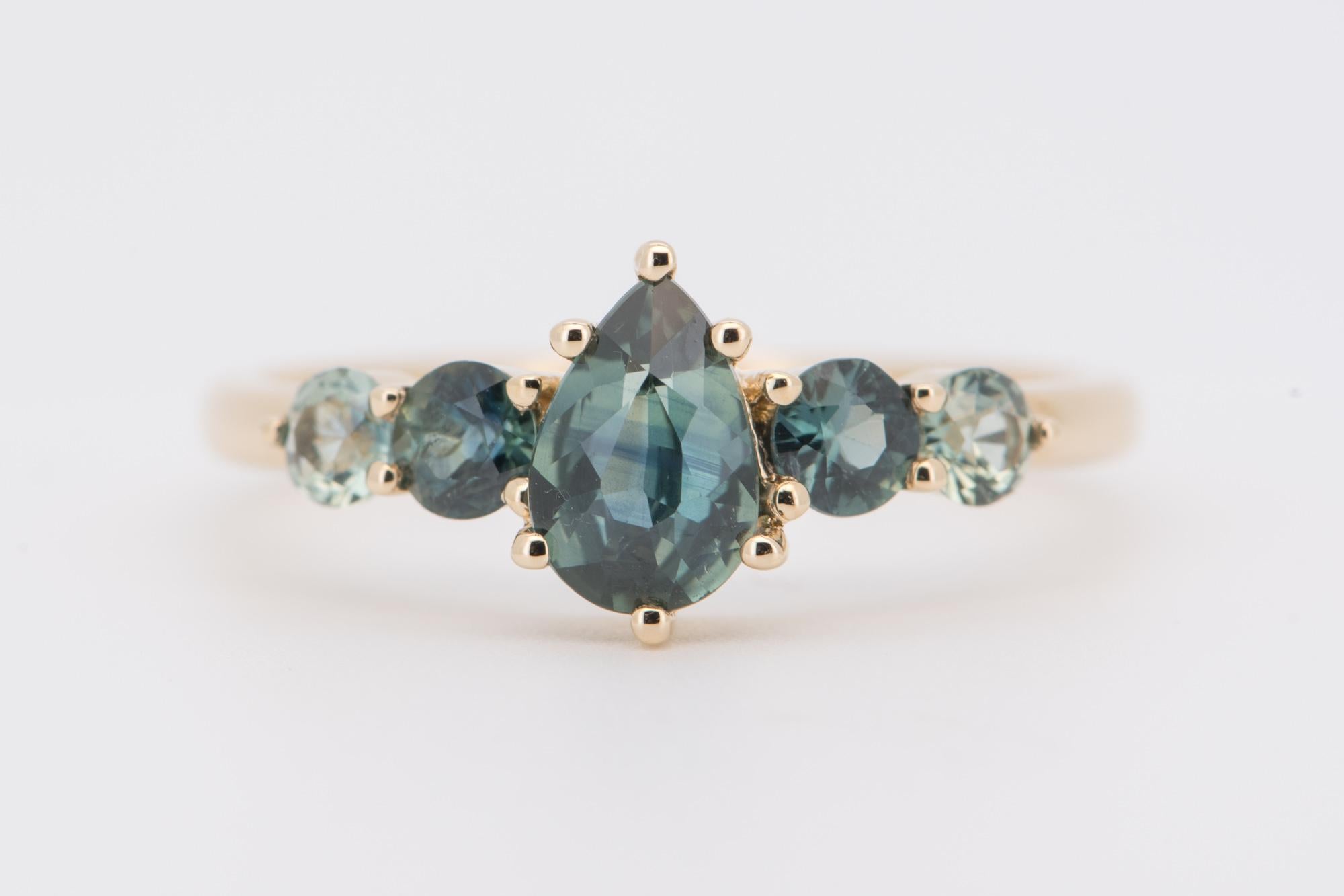 Declare your love with this unique Five-Stone Teal Sapphire Ring crafted from 14K gold! Its charming and sparkling cluster design will take their breath away! Will you say yes?

♥ This ring measures 8.3mm in length (North South direction), and