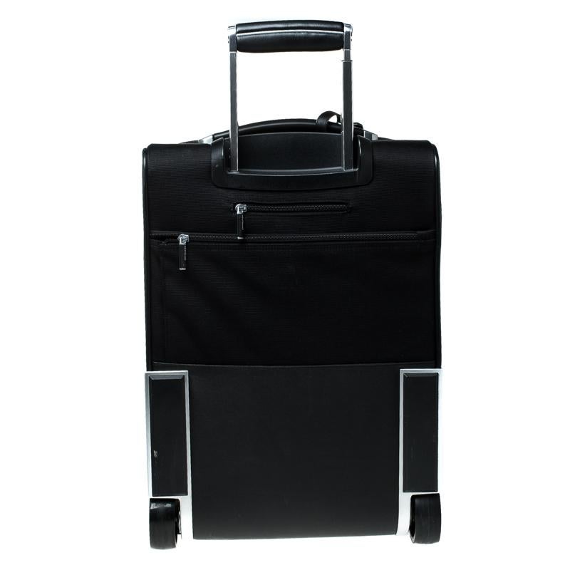Practical and subtle to look at, this Nightflight On-board luggage bag from Montblanc is made from black signature fabric and leather. Equipped with two wheels that offer unrestrained movement, the bag has top and side carry handles for extended