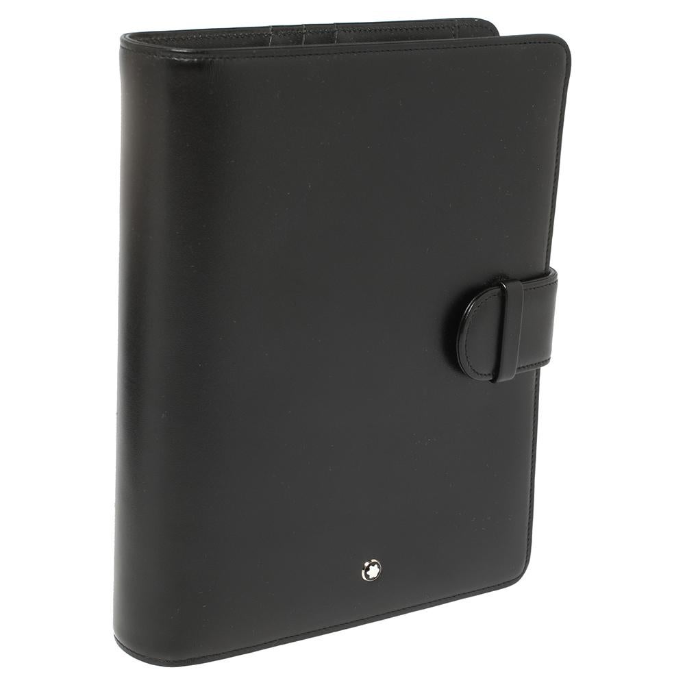 Montblanc Meisterstück large organizer designed with silver-tone metal rings holding organisation sheets and a black leather cover secured by a simple tuck-in clasp. The luxe accessory has card shots, a pen holder, and the iconic Montblanc emblem.
