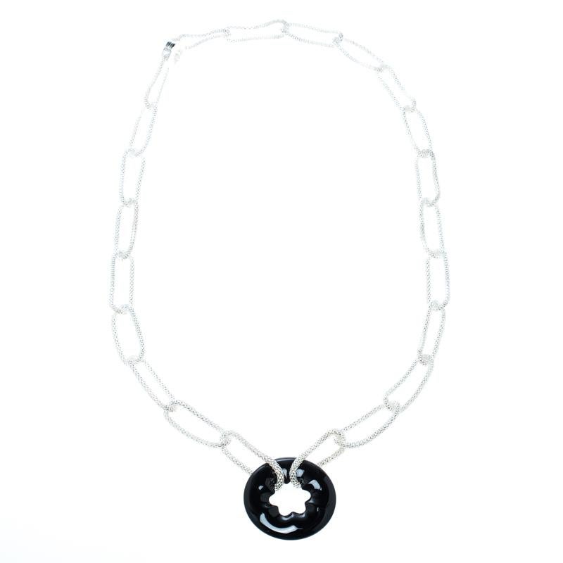 This beautiful and simple necklace from Montblanc's Star Collection is effortlessly chic and also subtly glamorous for both day and night time use. It features a long silver chain-link with a black, onyx star emblem as the pendant; hence, giving the