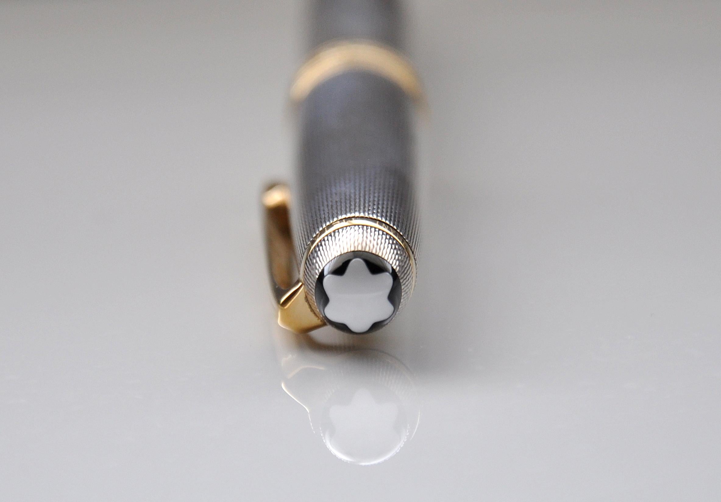 A vintage 925 silver Montblanc Meisterstück 165 mechanical pencil, in the barley corn pattern. The pencil has a mechanical twist mechanism with 0.7 mm lead. The barrel and cap of this pencil are made of 925 sterling silver and feature a guilloche