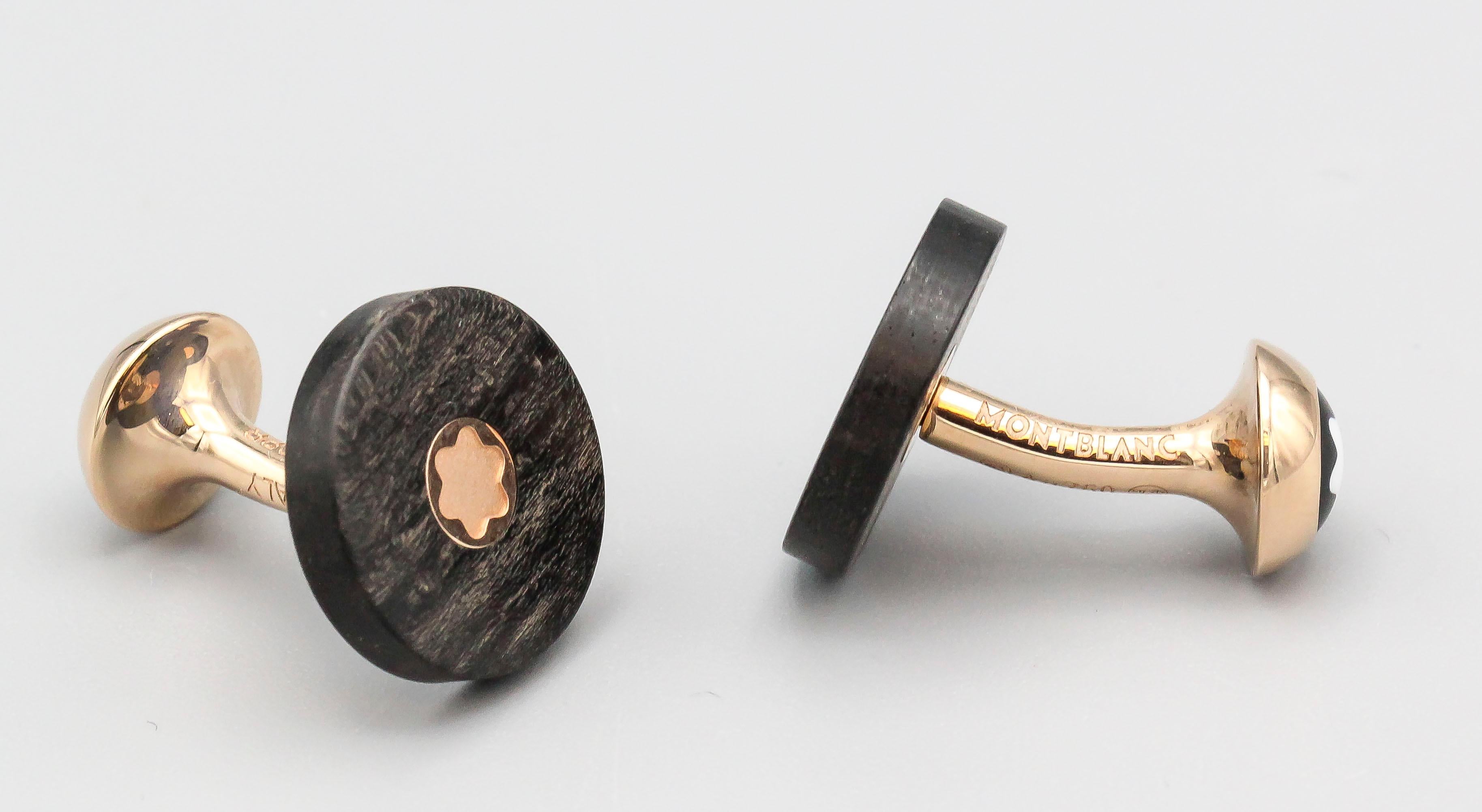 Fine pair of wood and 18k rose gold cufflinks by Montblanc. The front of the cufflinks features a polished wood disc with the gold Montblanc signature six point star, while the opposite end of the cufflinks feature the classic six point star in