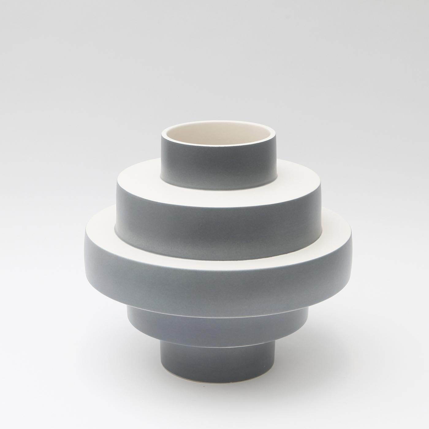 Elegant and dynamic in design, the Montée vase is entirely handcrafted in matte gray ceramic. The clever shape features layers of concentric circles widening in the middle and becoming narrow at the top and bottom. Show off your favorite flowers in