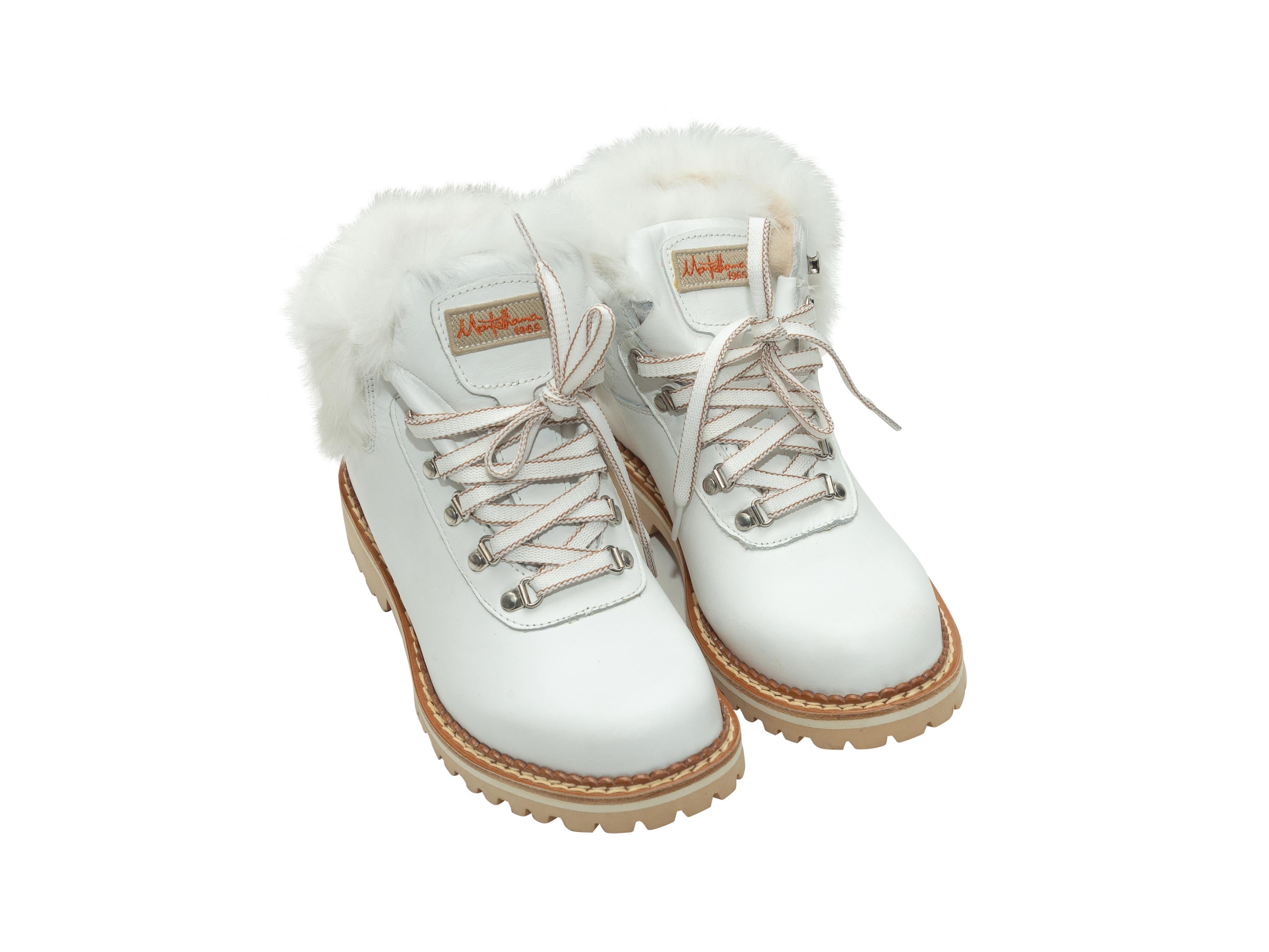 Product details: White leather round-toe fur-trimmed work boots by Montelliana. Lug soles. Lace-up tie closures at tops. 1.25