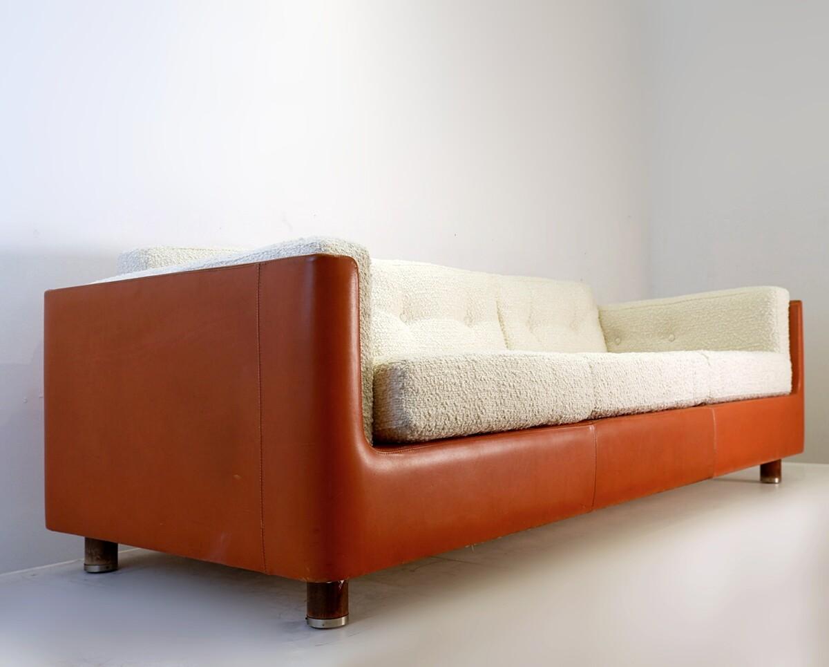 Three seater sofa with orange leather footing and white 
