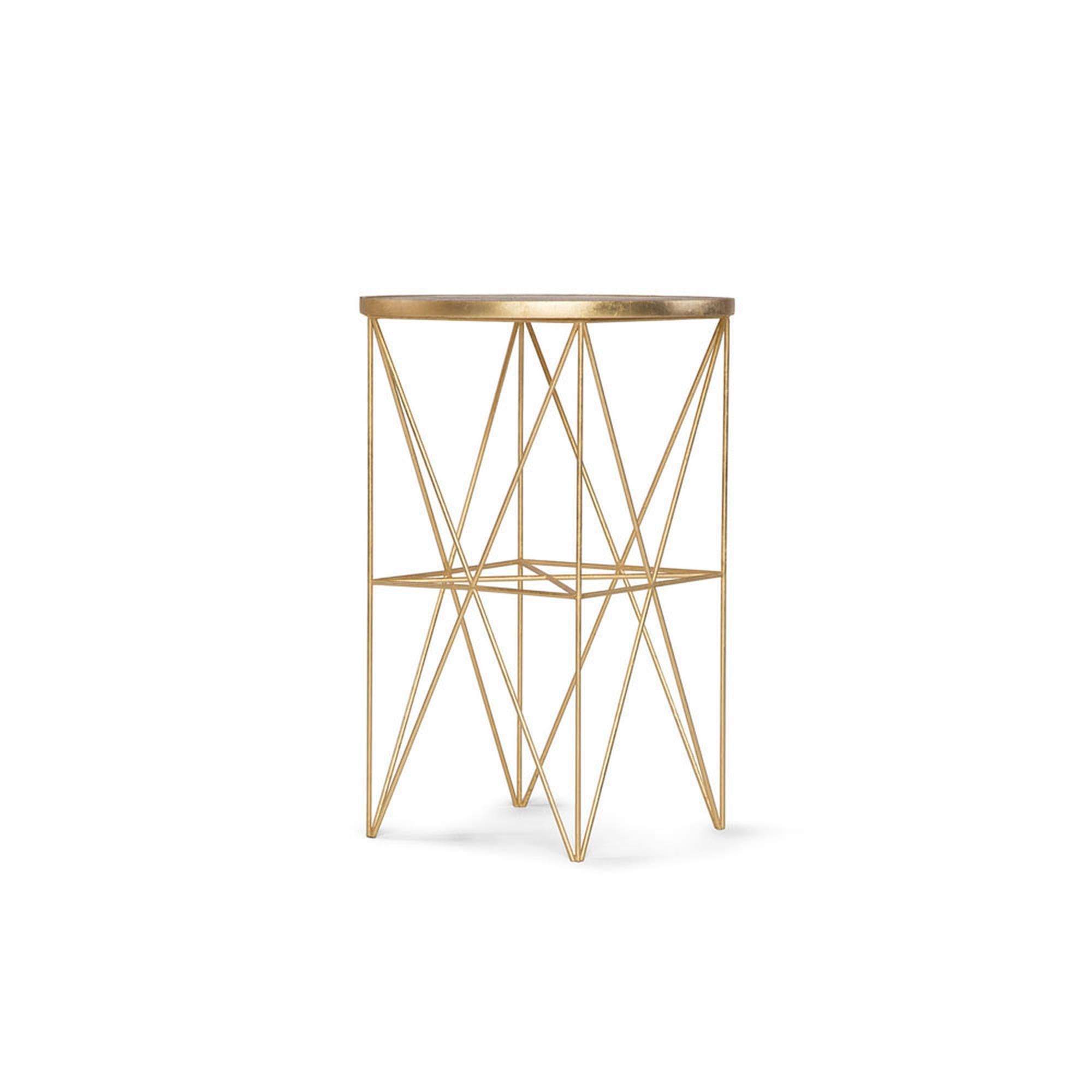 This handmade Monterey tall side table features an intricate hand-gilded metal base and a hand- nished wood top. Elegant and functional, this side table uni es style and aesthetic by adding a touch of Old Hollywood glitz on a hand-gilded geometric